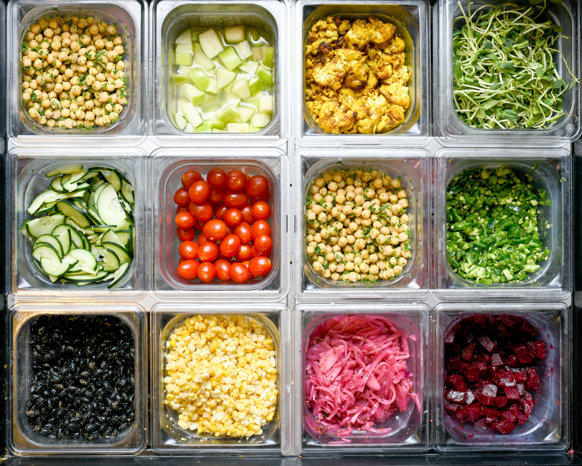 Different plant-based ingredients, including beets, pickled red onions, and black beans, are used to build a meal at Forage Kitchen.