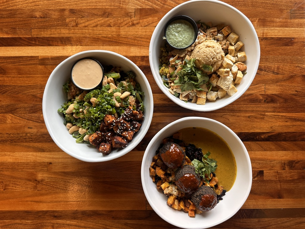Three Forage Kitchen, including Thai Bowl, Cashew Bowl, and Club Med Bowl with plant-based ingredients.