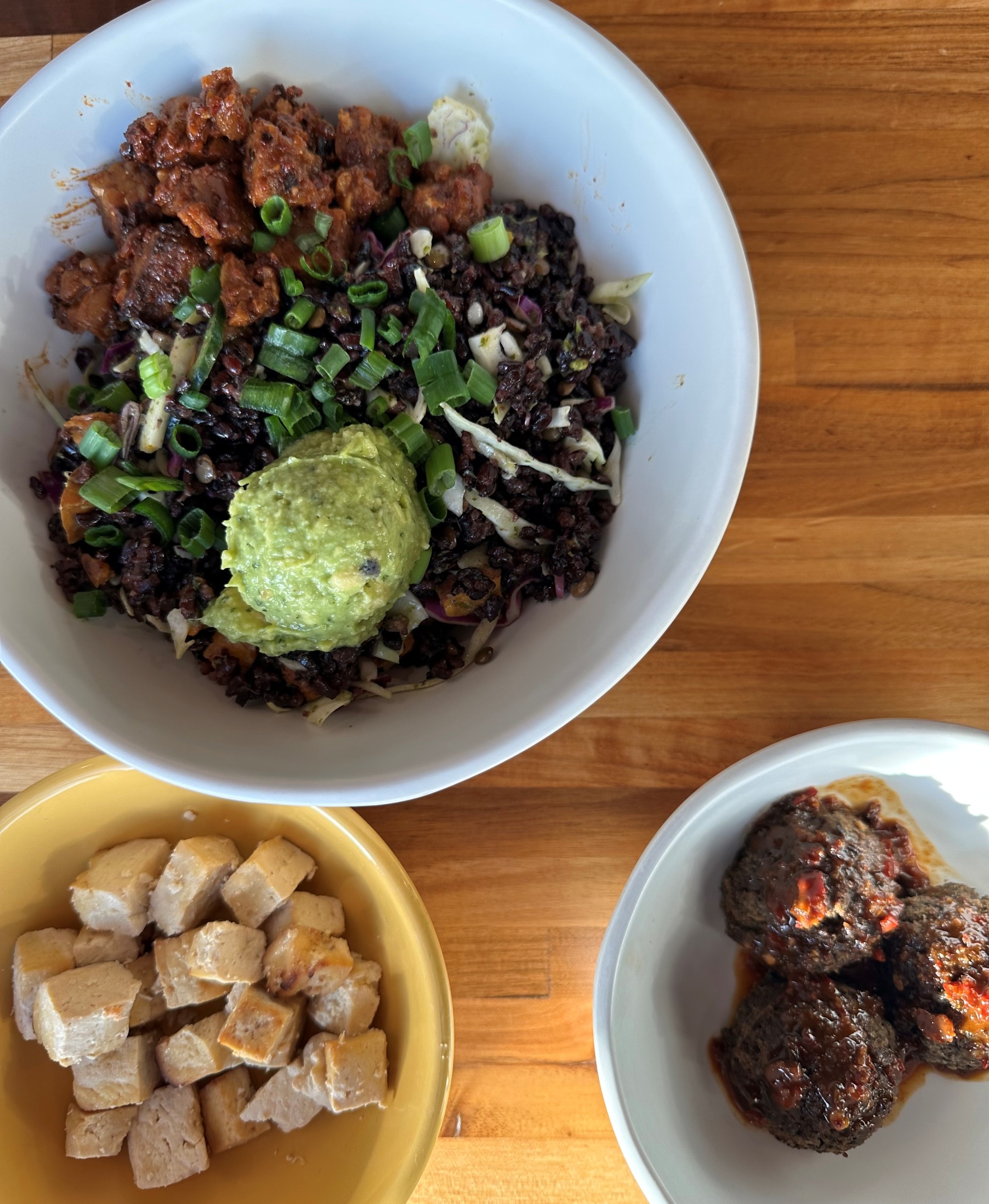 Forage Kitchen grain bowl with black rice, guacamole, and sides of tofu and lentil meatballs.