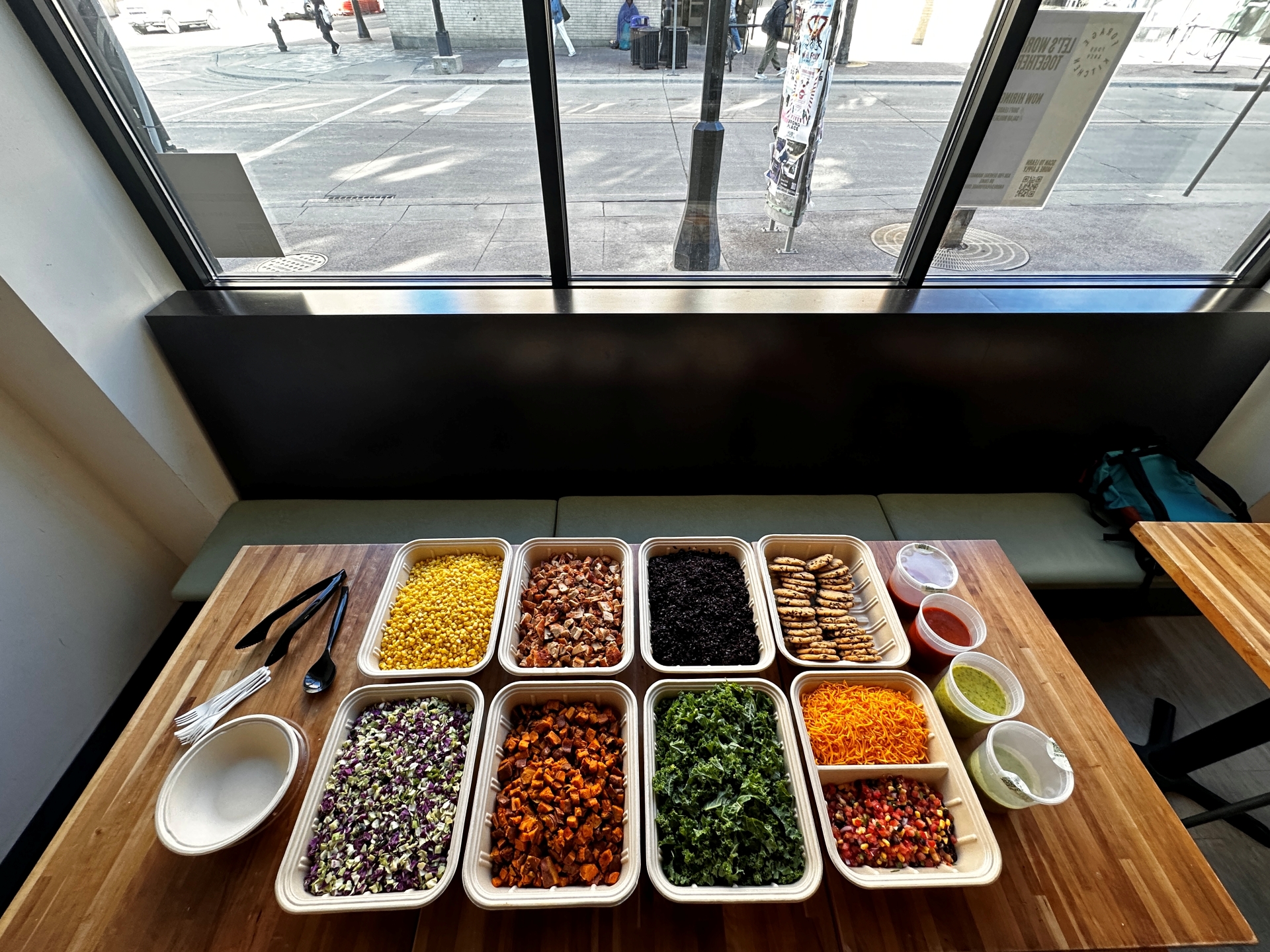 A colorful, fresh build-your-own bowl station set up for a corporate wellness catering event at Forage Kitchen.
