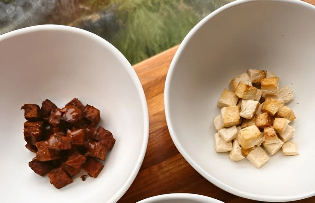 Three white bowls featuring plant-based proteins: seasoned tofu and tempeh at Forage Kitchen.