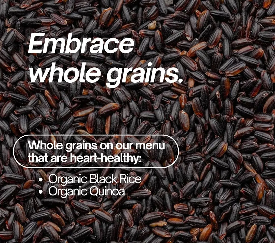 A close-up of organic black rice grains used at Forage Kitchen with overlay text listing heart-healthy whole grains.