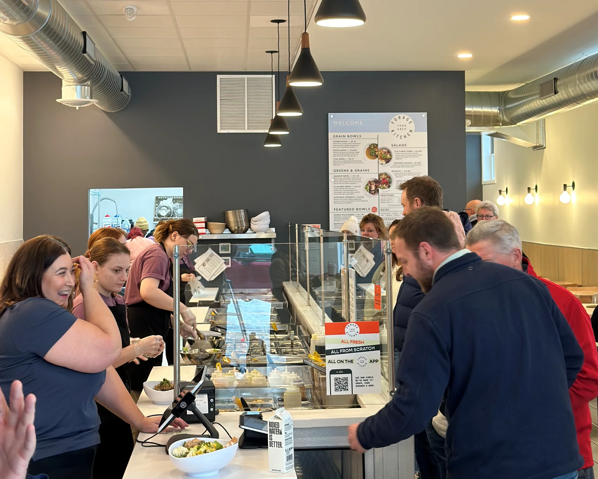 Customers waiting in line at Forage Kitchen restaurant counter in Whitefish Bay to place their food orders.