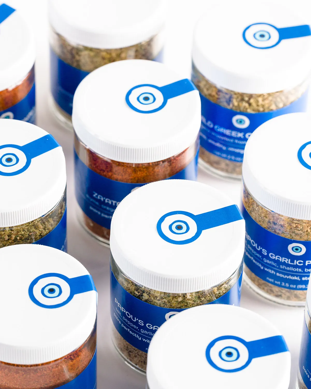 Jars of The Gyro Project's Greek spice blends, including za'atar and garlic seasoning