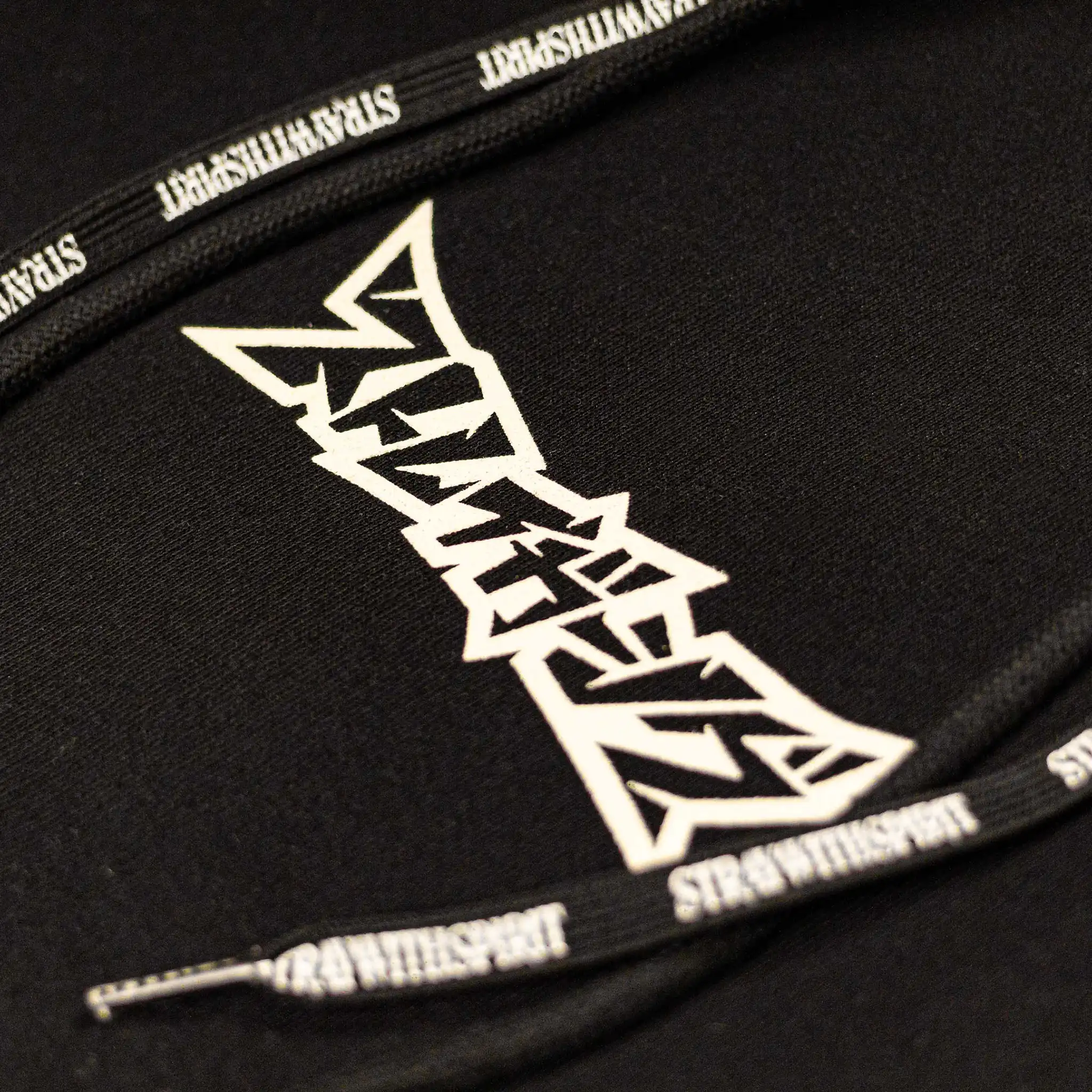 Straygang Spirit Hoodie in black, chest detail of sharp white Japanese logo print with branded drawstrings.