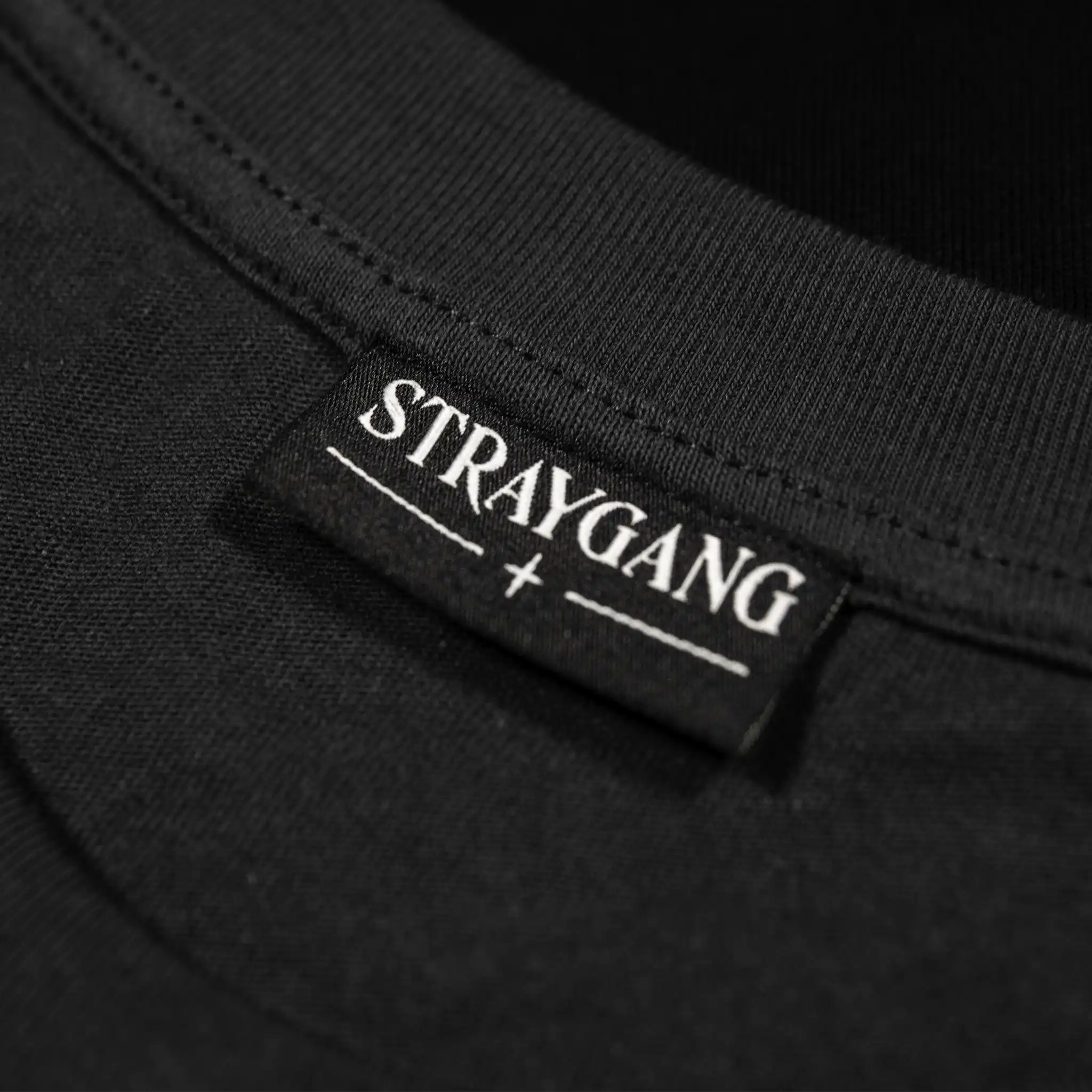 Straygang Supernova Tee in grey, close-up of inner neck label with woven Straygang logo.