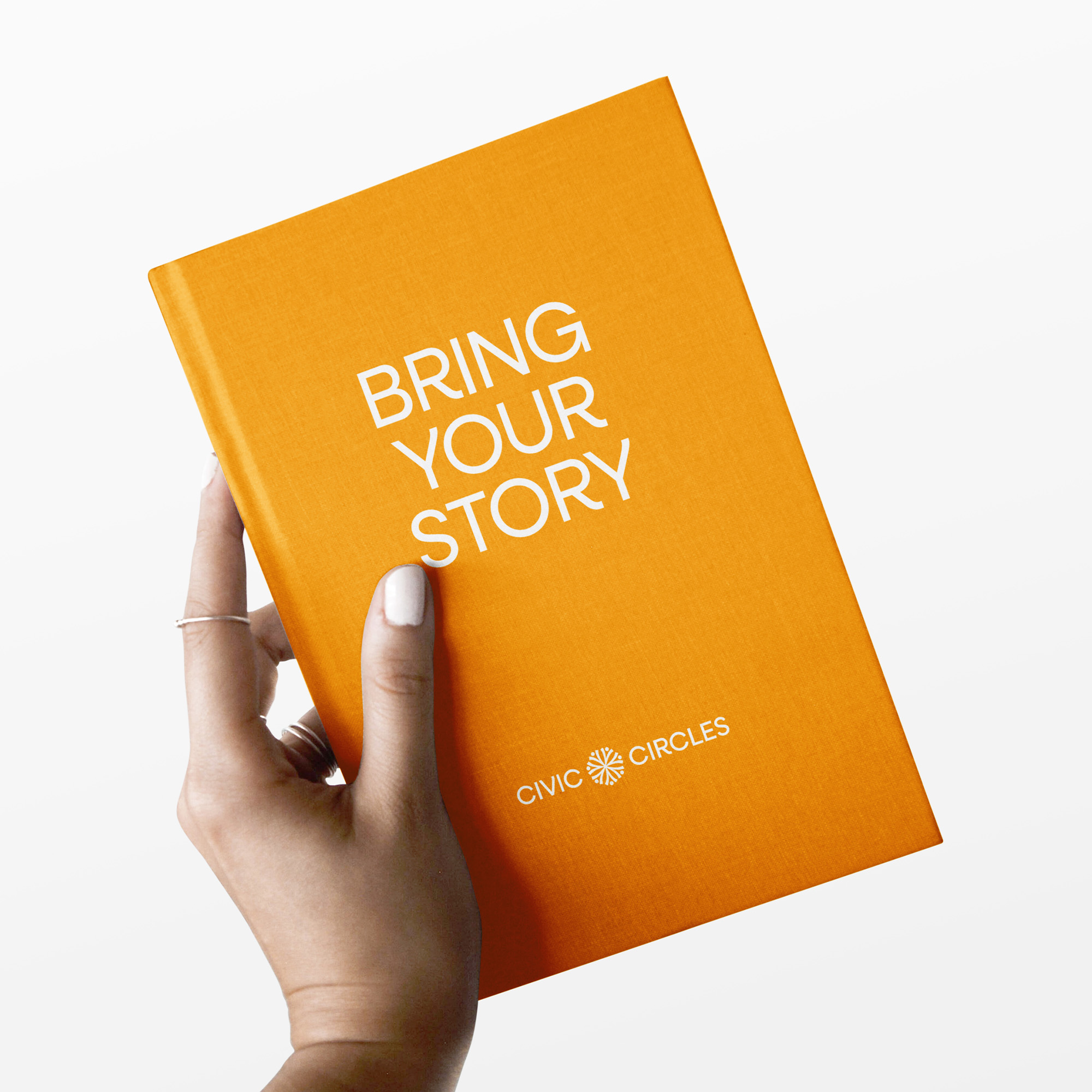 A mockup showing a lady holding a branded orange notebook that says "Bring your story."
