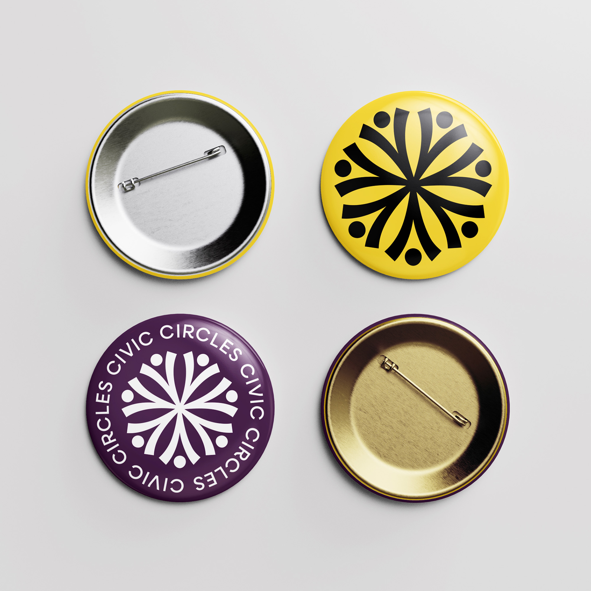 A metal pin mockup showing a branded yellow and a purple design. 