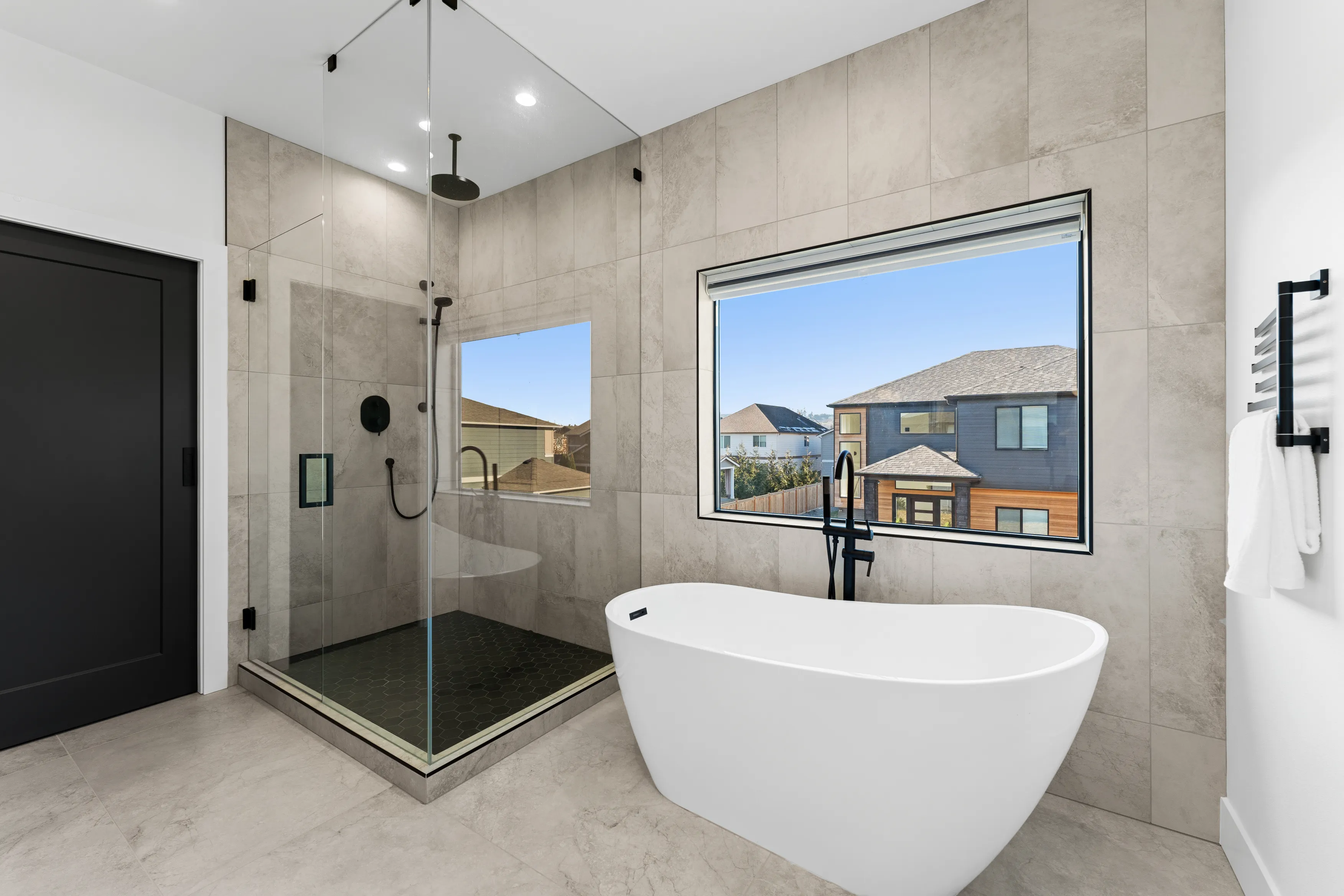 Open-concept kitchen in a custom Issaquah home with contemporary cabinetry, island seating, and modern lighting.