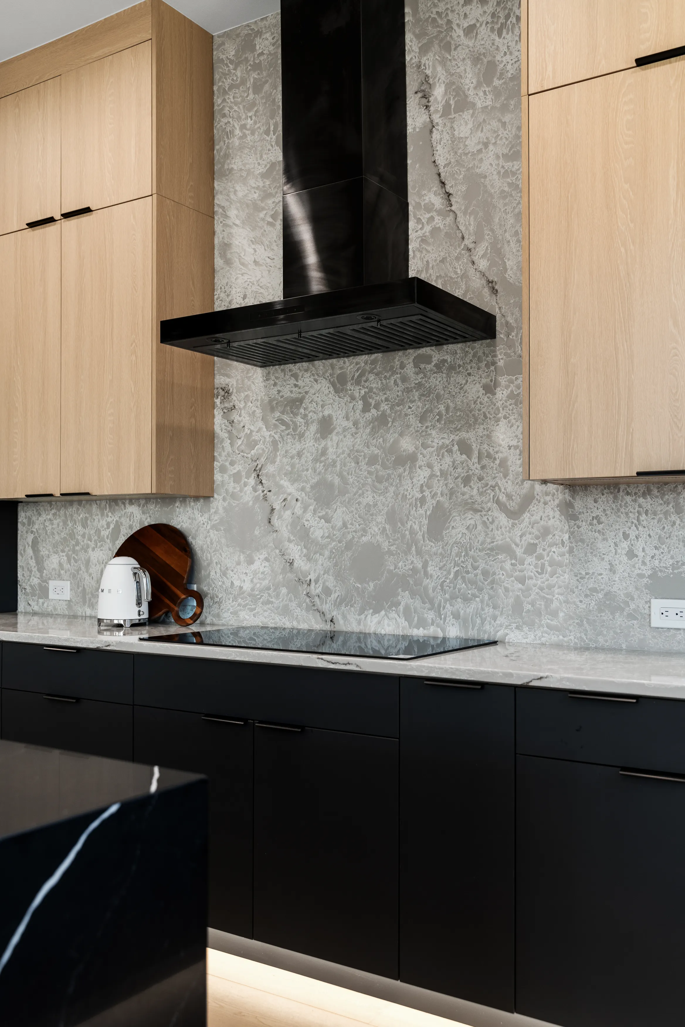 Open-plan custom kitchen in Issaquah showcasing minimalist cabinetry, large island workspace, and modern lighting.