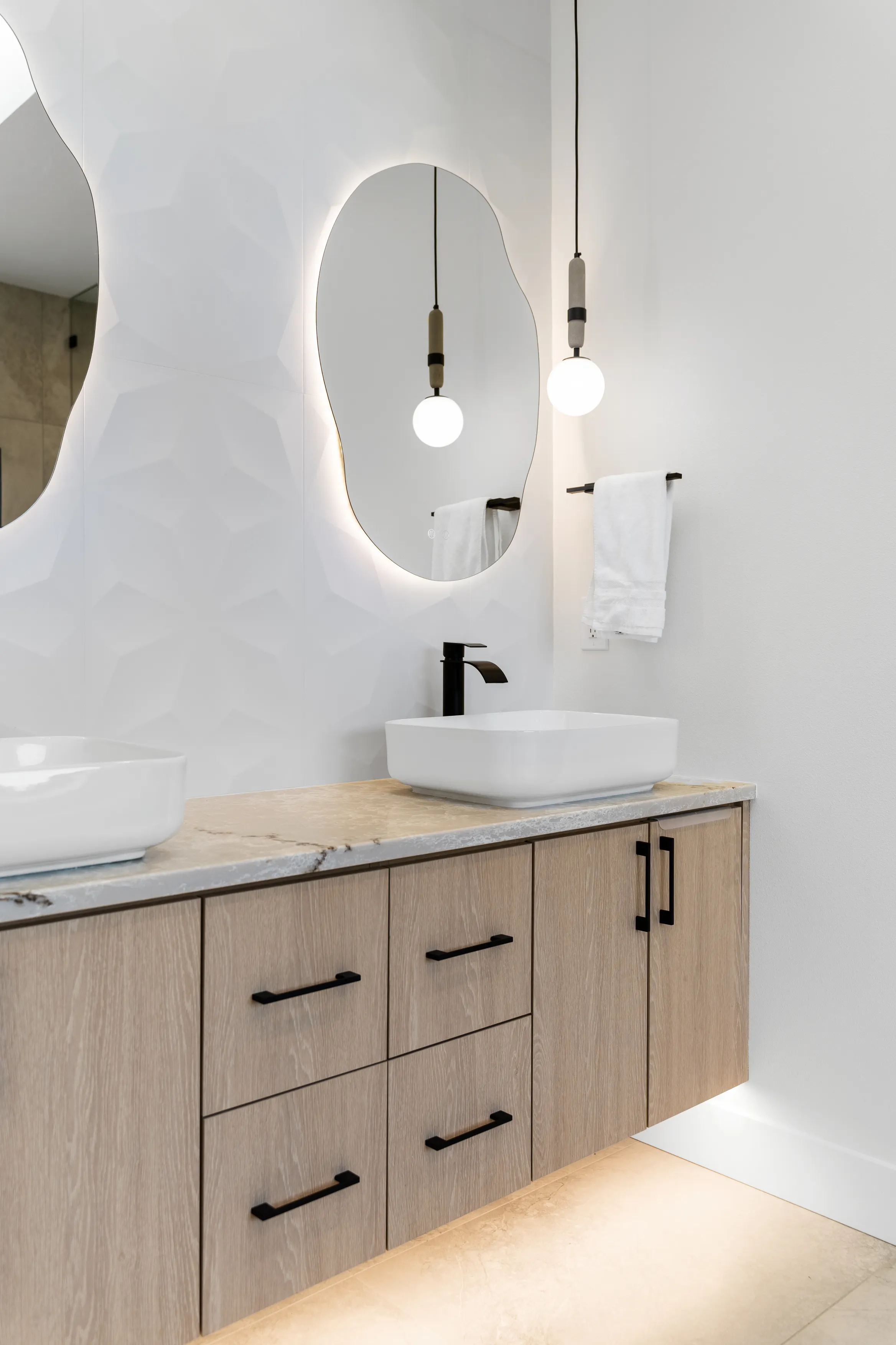 Custom home bathroom in Issaquah with spa-inspired design, large window, walk-in shower, and modern fixtures.