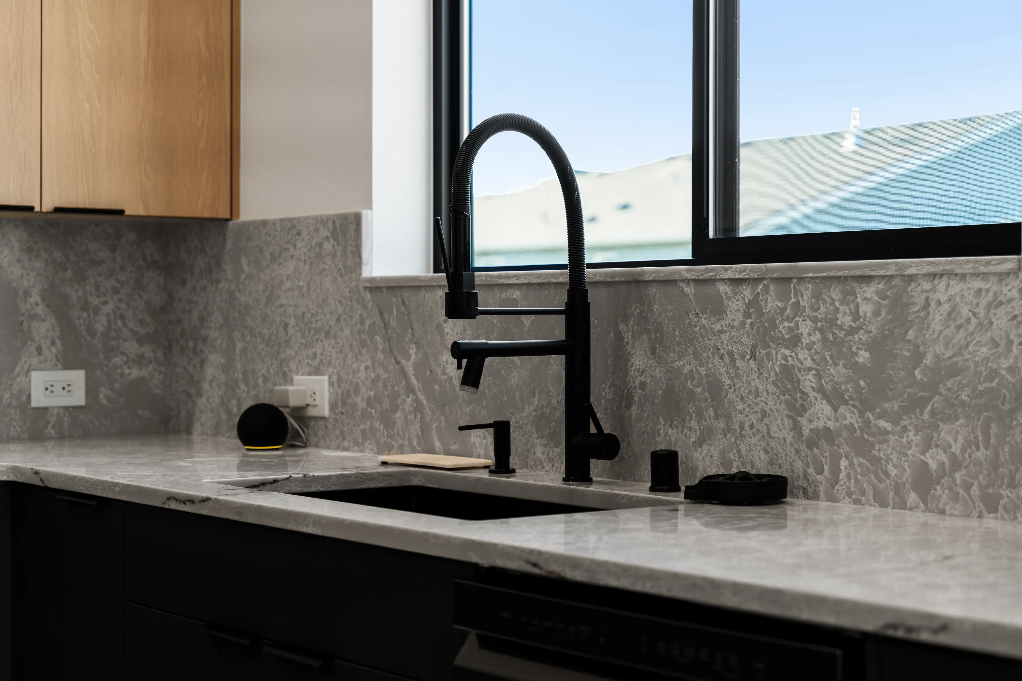 Sleek matte black kitchen faucet installed in a custom modern kitchen in Issaquah.