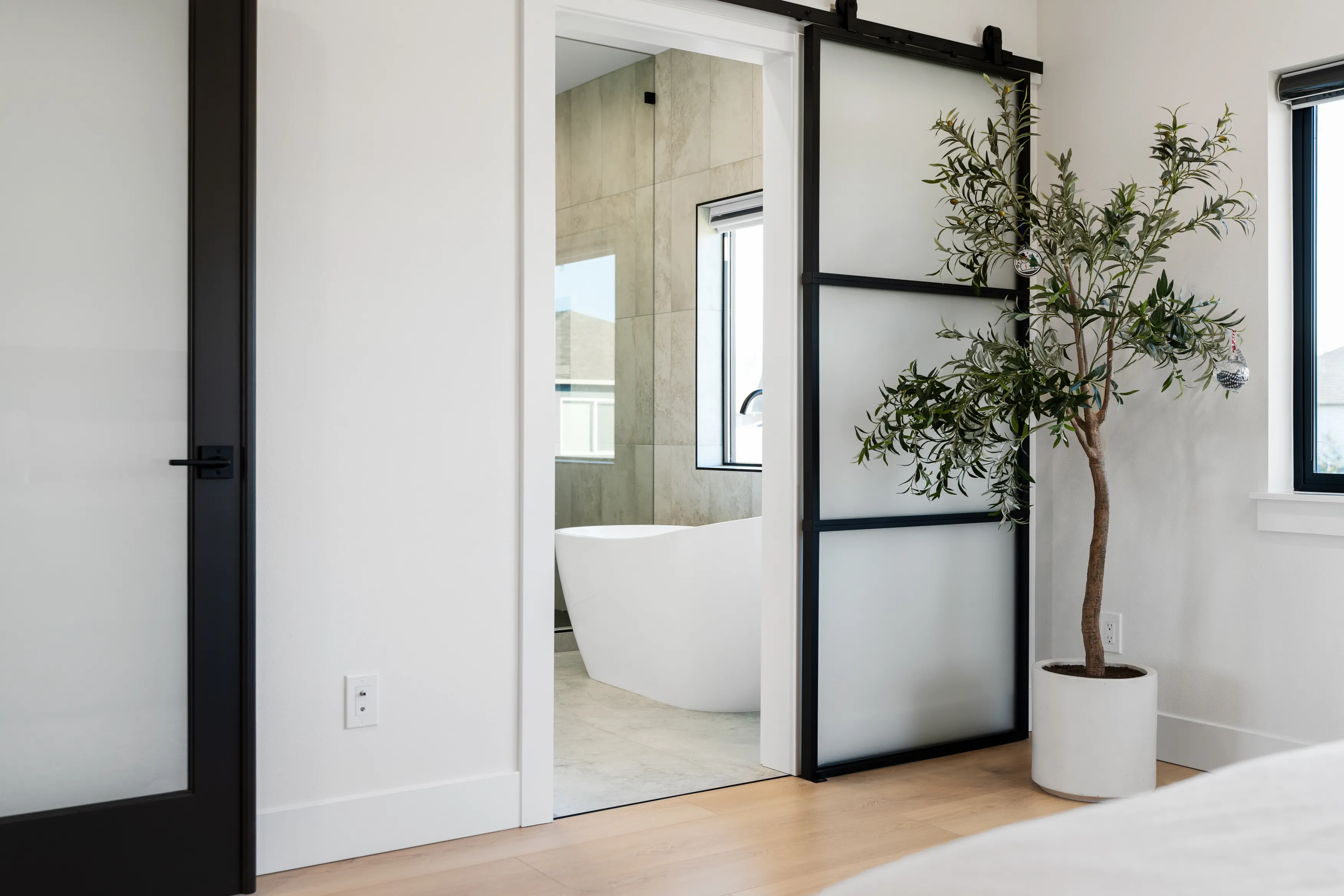 Luxury modern bathroom in a custom Issaquah home with natural light, soaking tub, and minimalist shower design.Contemporary custom bathroom in Issaquah showcasing a glass-enclosed shower, freestanding tub, and clean modern finishes.
