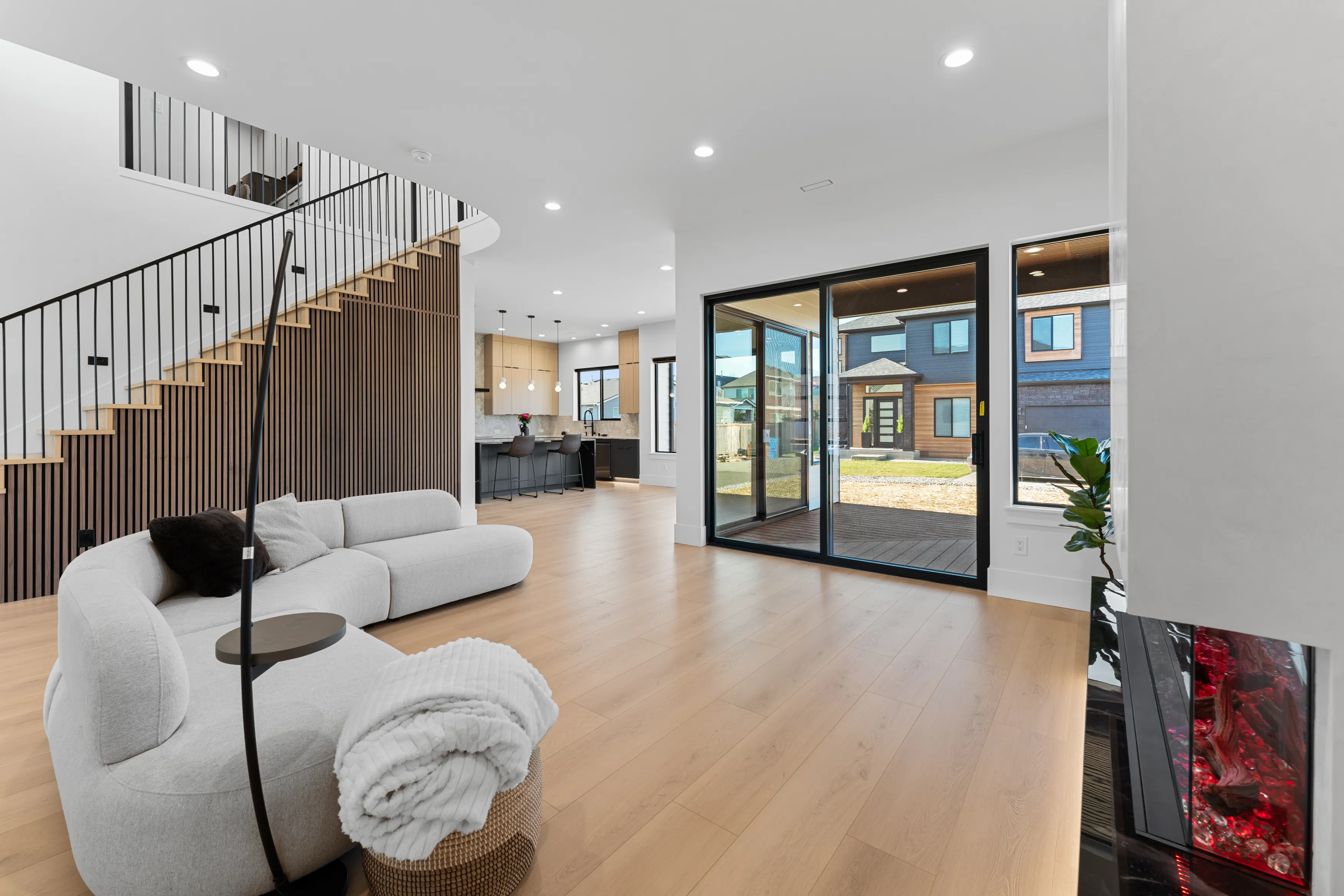 Interior of a modern custom-built home in Issaquah showcasing an open stairway, minimalist railing, and bright living space.