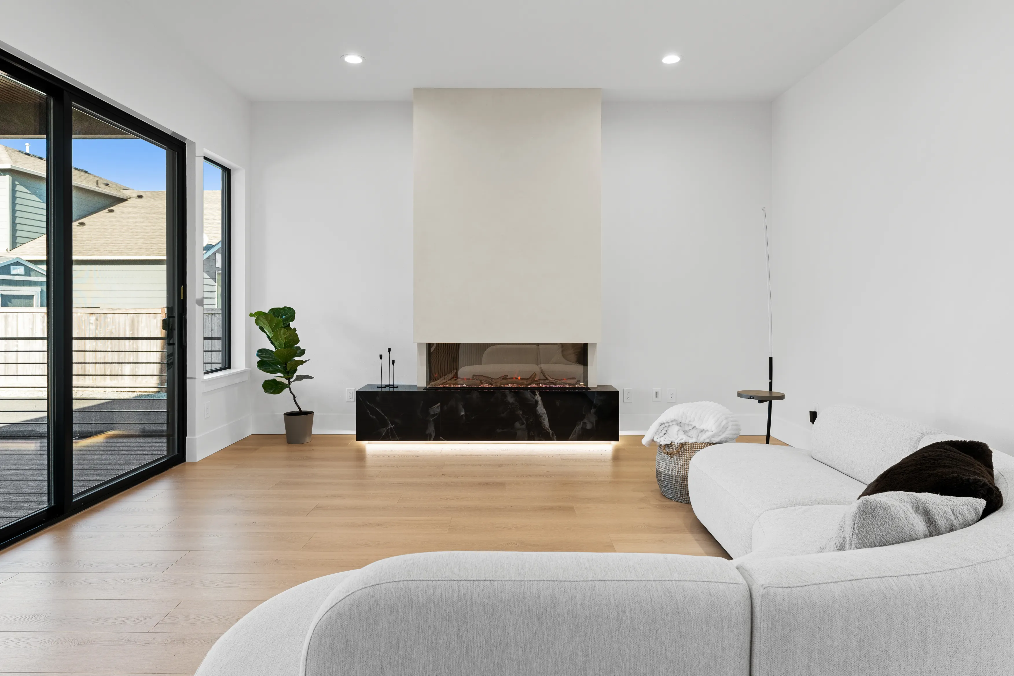Interior of a modern custom-built home in Issaquah showcasing an open stairway, minimalist railing, and bright living space.