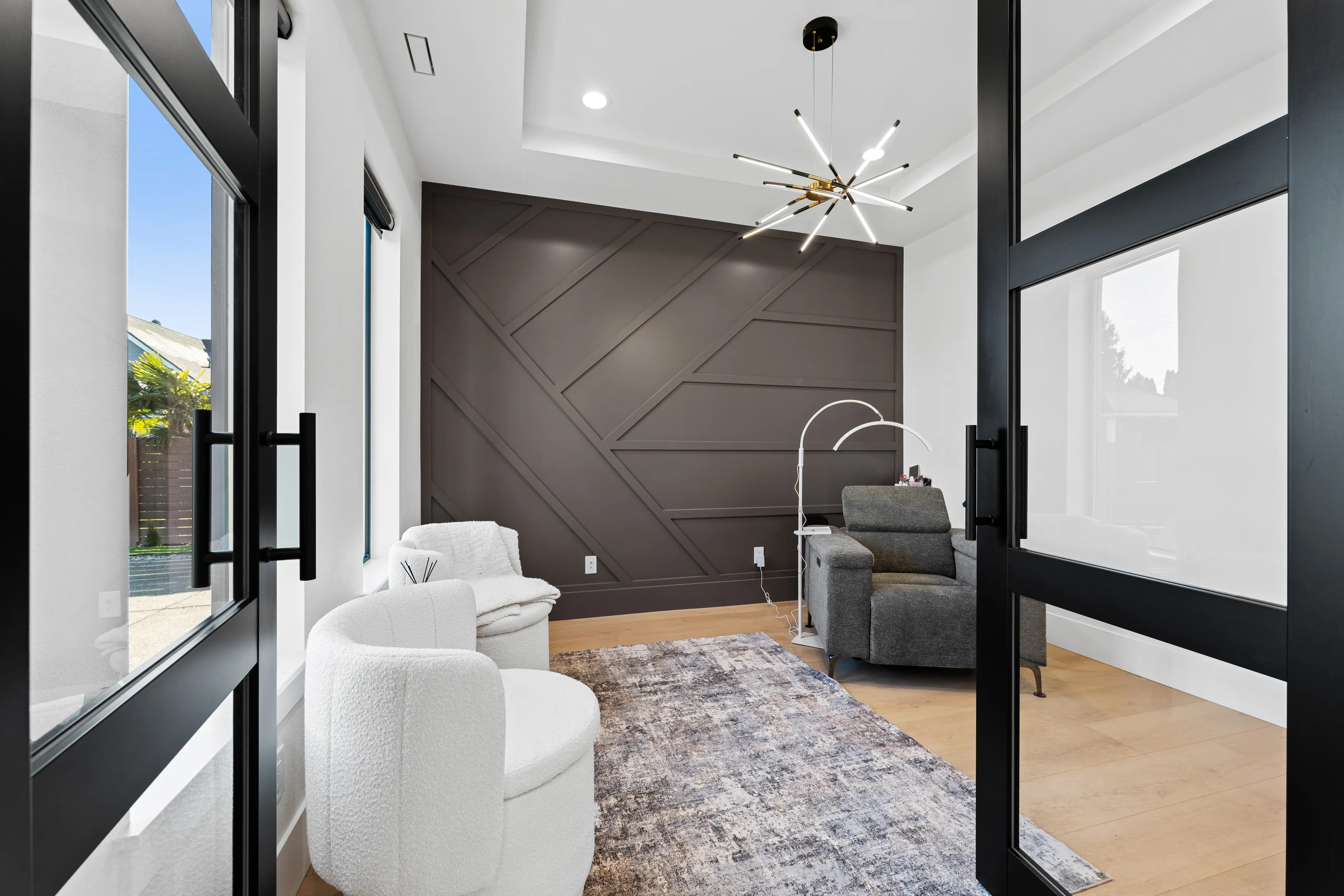 Bright open-concept living space in a custom Issaquah home with light wood floors, modern staircase, and clean contemporary lines.