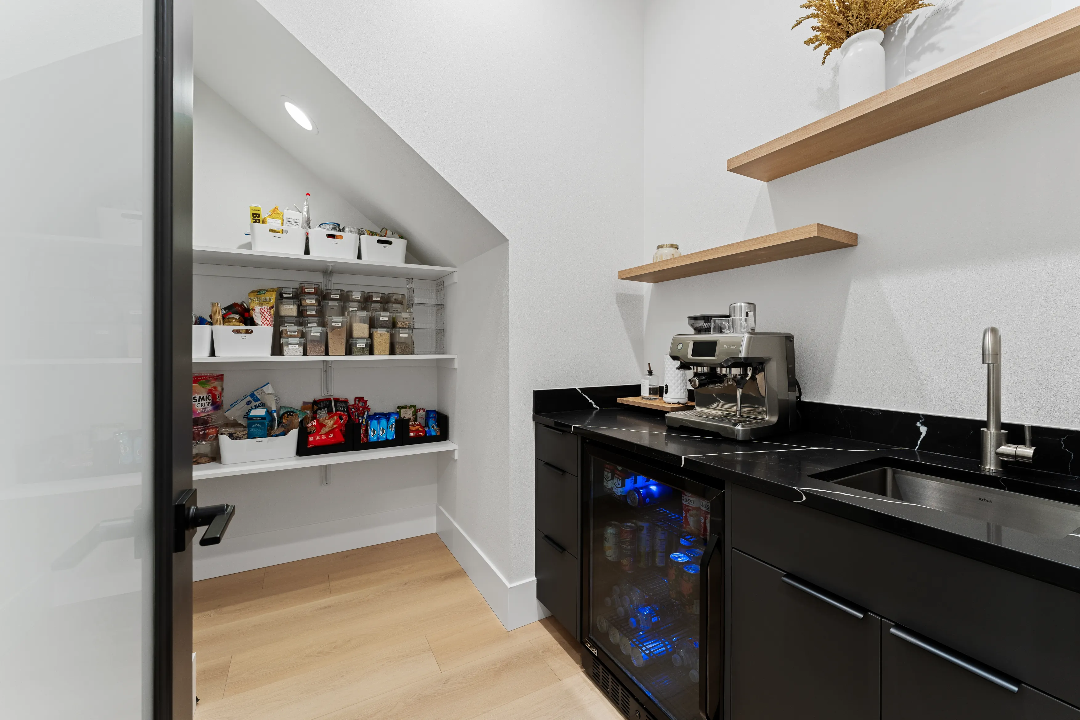 Modern black kitchen faucet in a custom Issaquah home, featuring a minimalist design and contemporary finish.