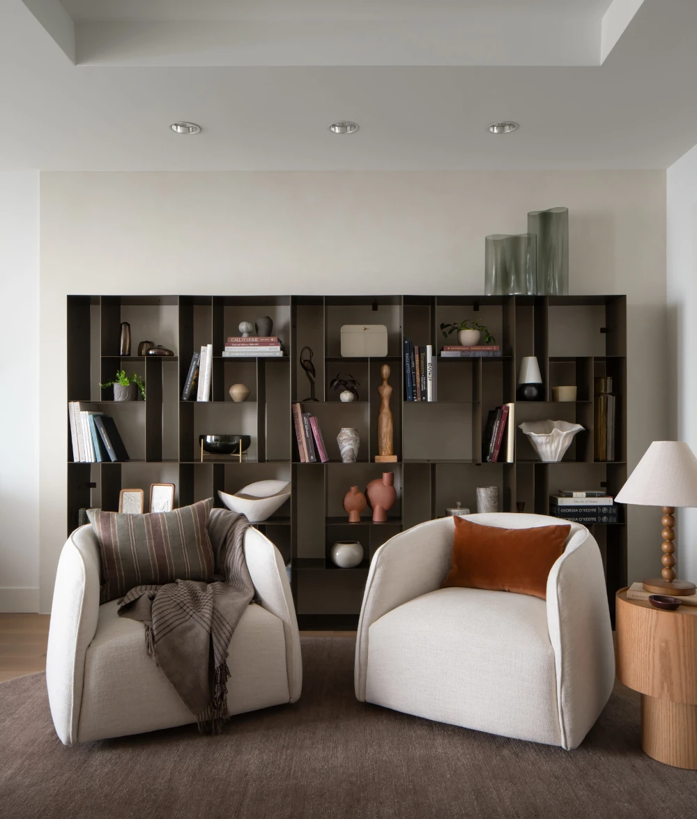 Luxury condo living room featuring custom finishes and seating.