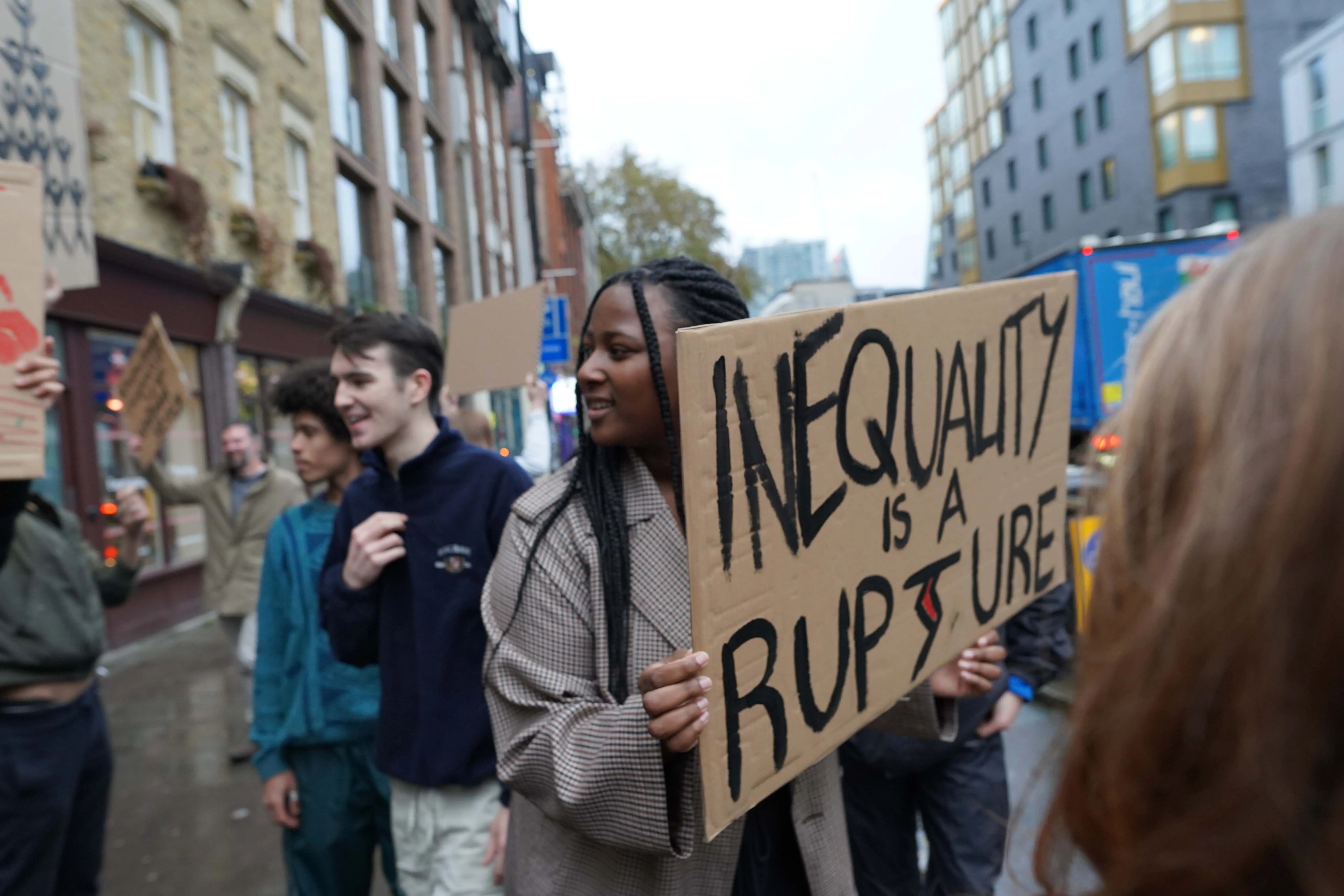 Several people in a protest about inequality