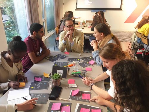 Faculty members collaborating at a table.