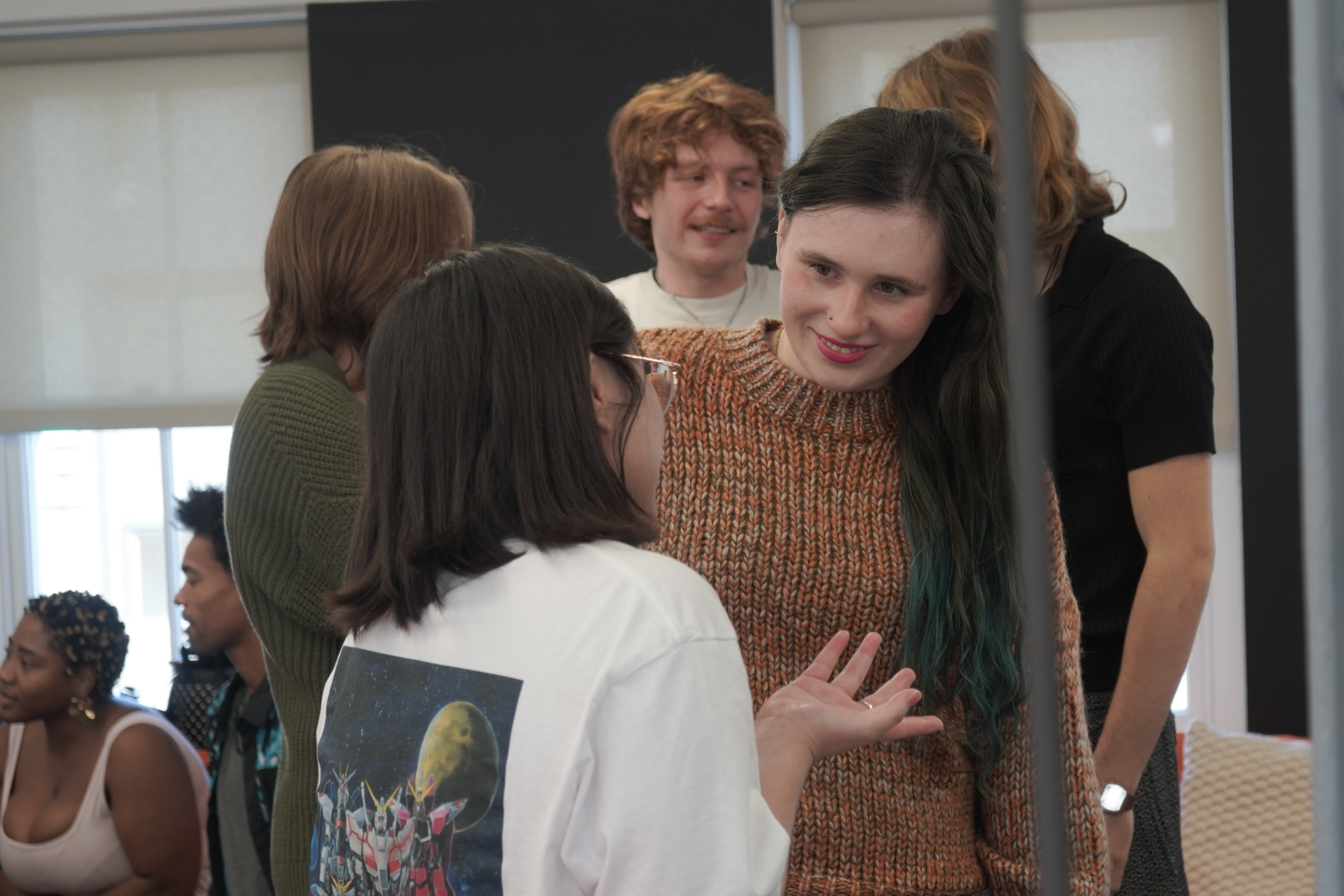 Students Collaborating in a Modern Classroom Students working together and discussing ideas in a contemporary academic setting.