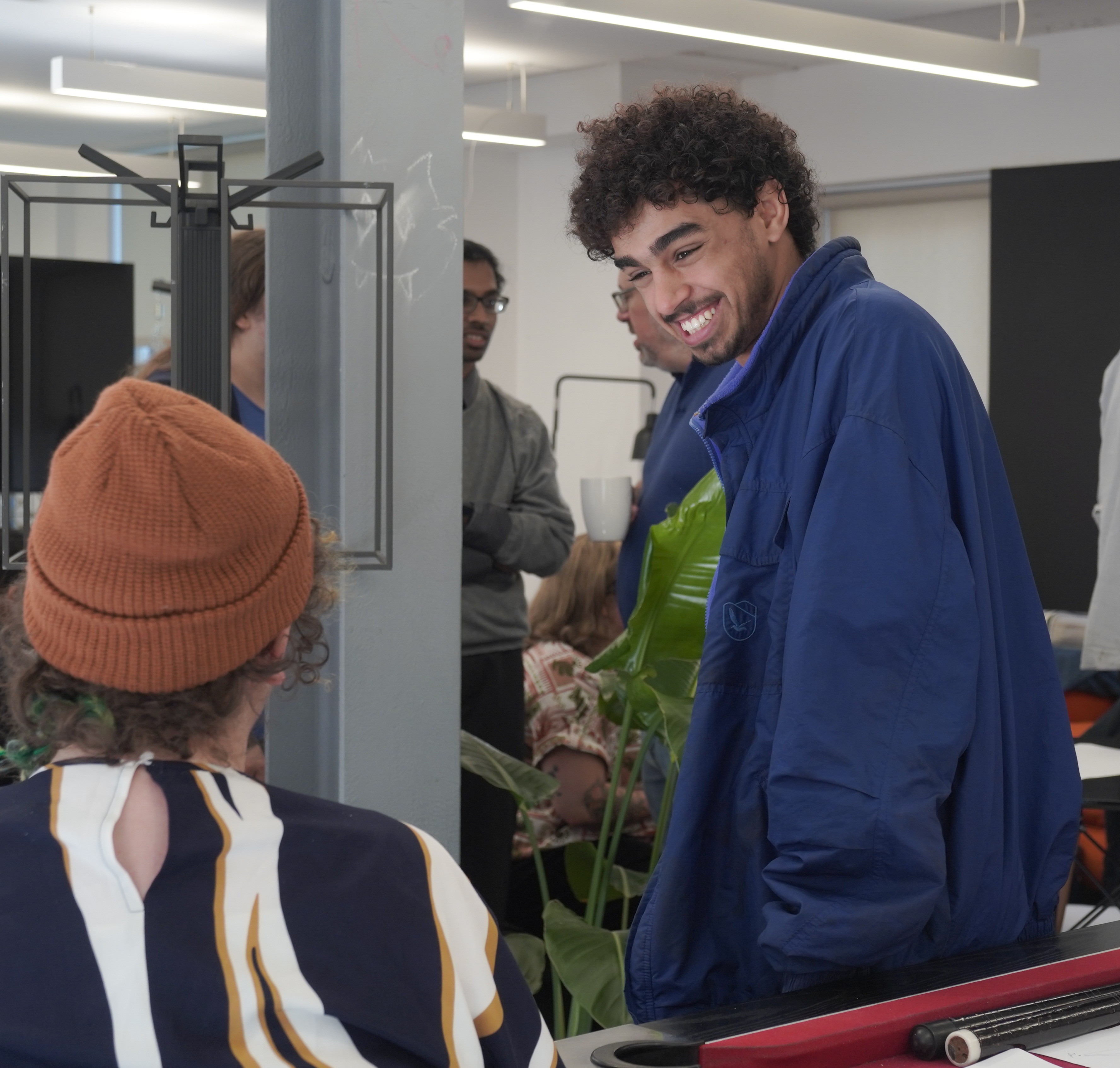 Group of Students and Faculty Posing in a Stylish Space A group of students and a faculty member posing together in a modern, stylish environment.