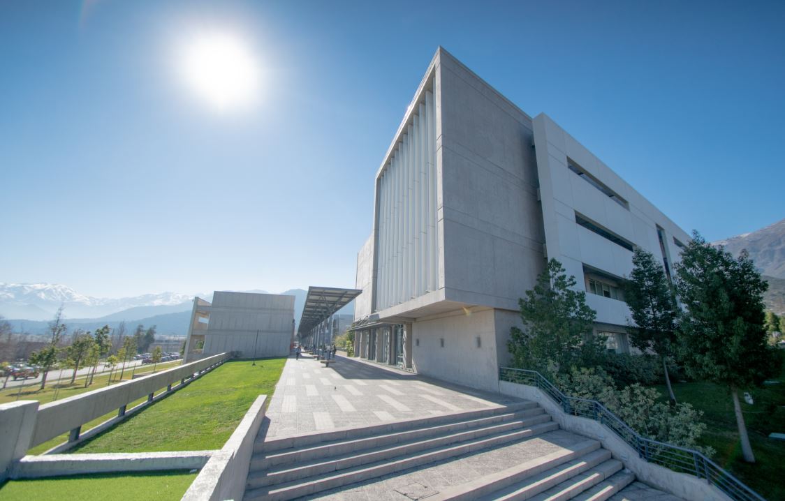 Student listening to lecturer in a busy classroom.