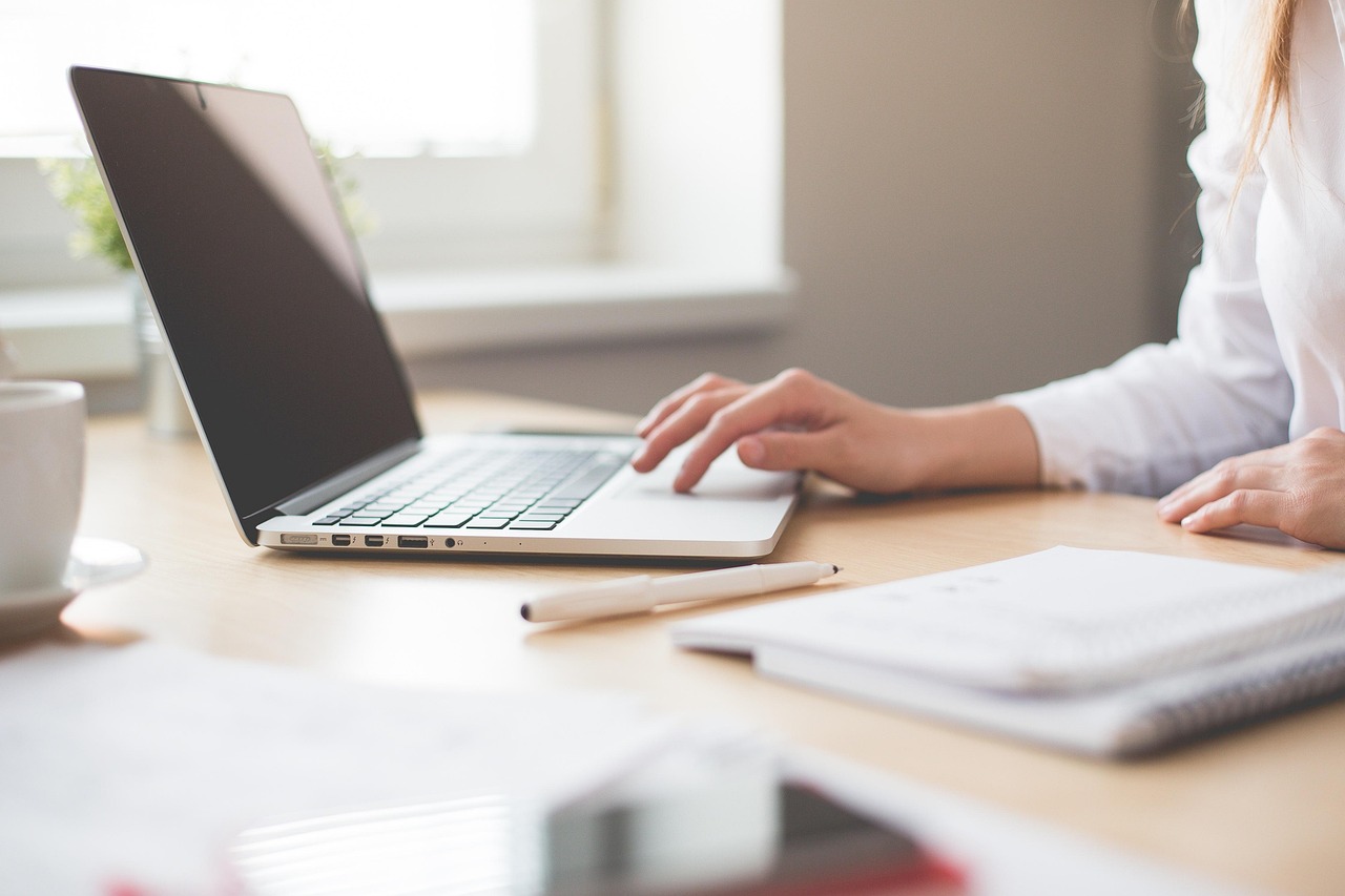 A woman navigating a laptop