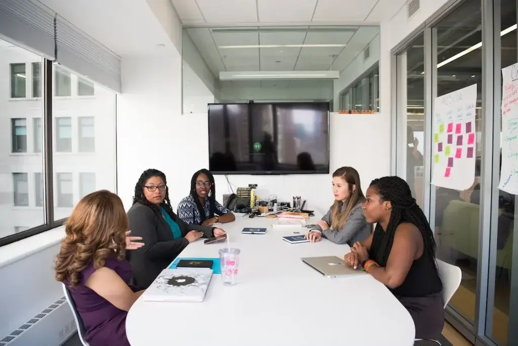 Five women in a meeting room