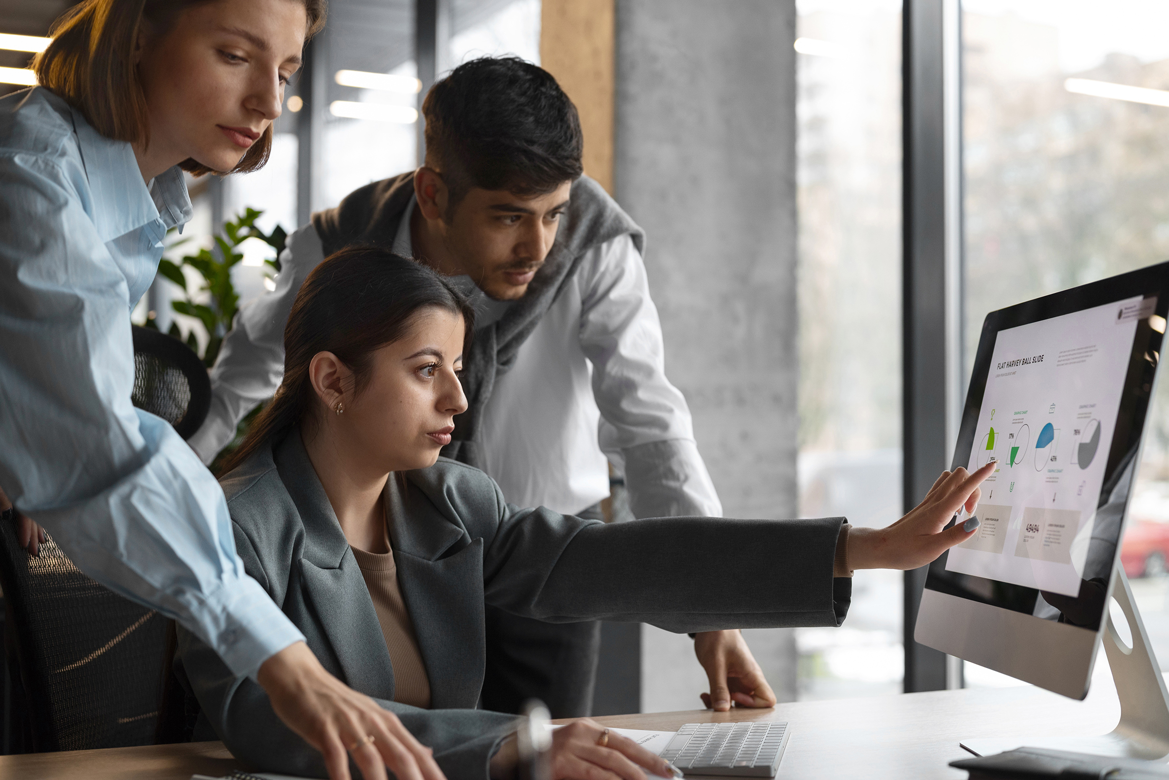 Choosing fewer KPIs for a business intelligence dashboard: a team reviewing key performance indicators together on one screen.