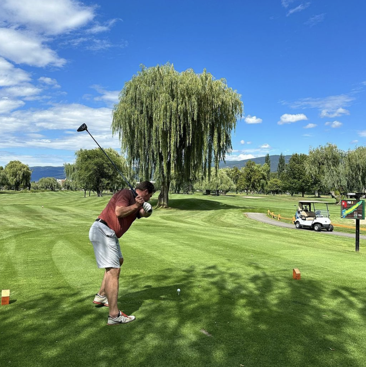 A guest golfing at the Penticton Golf & Country Club next to the Balcomo, A Ramada By Wyndham in the perfect blue skies