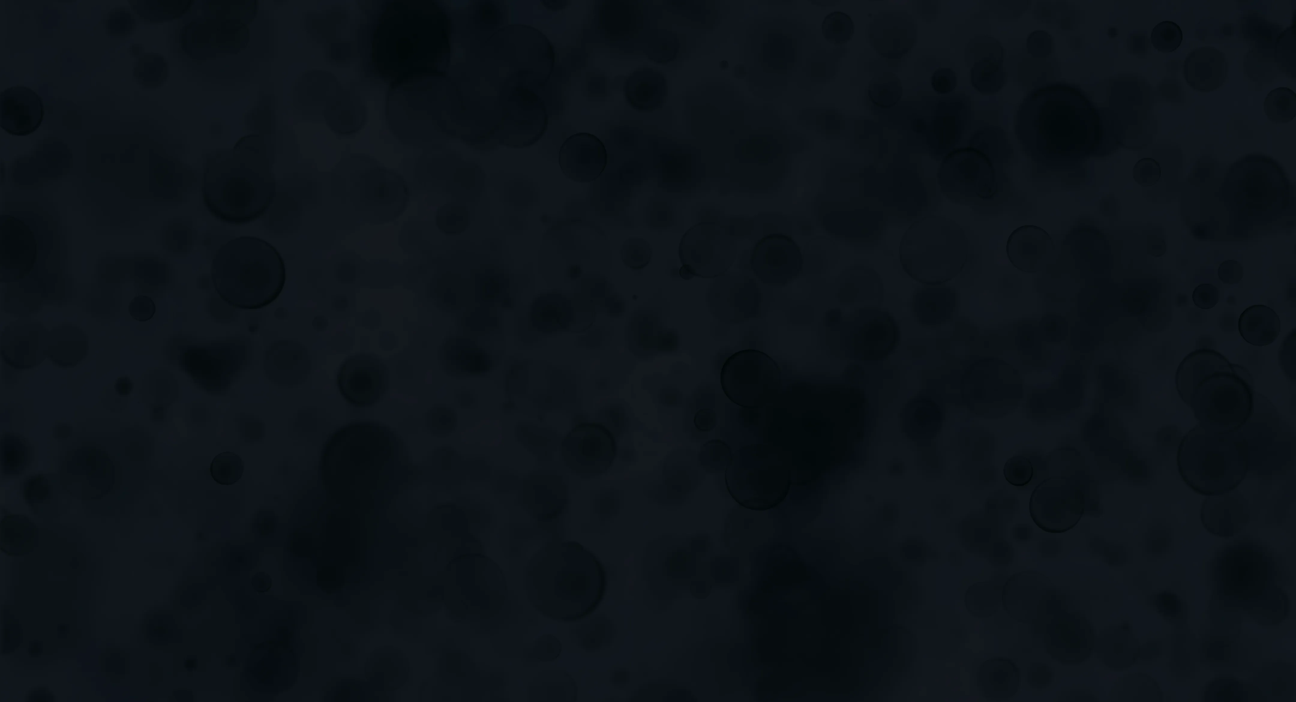 Dark background with numerous translucent black bubbles of varying sizes scattered throughout.