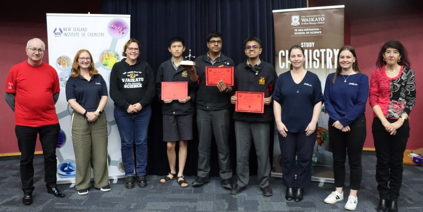 A group of people holding red certificatesAI-generated content may be incorrect.