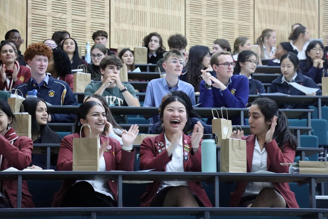 A group of people sitting in bleachersAI-generated content may be incorrect.