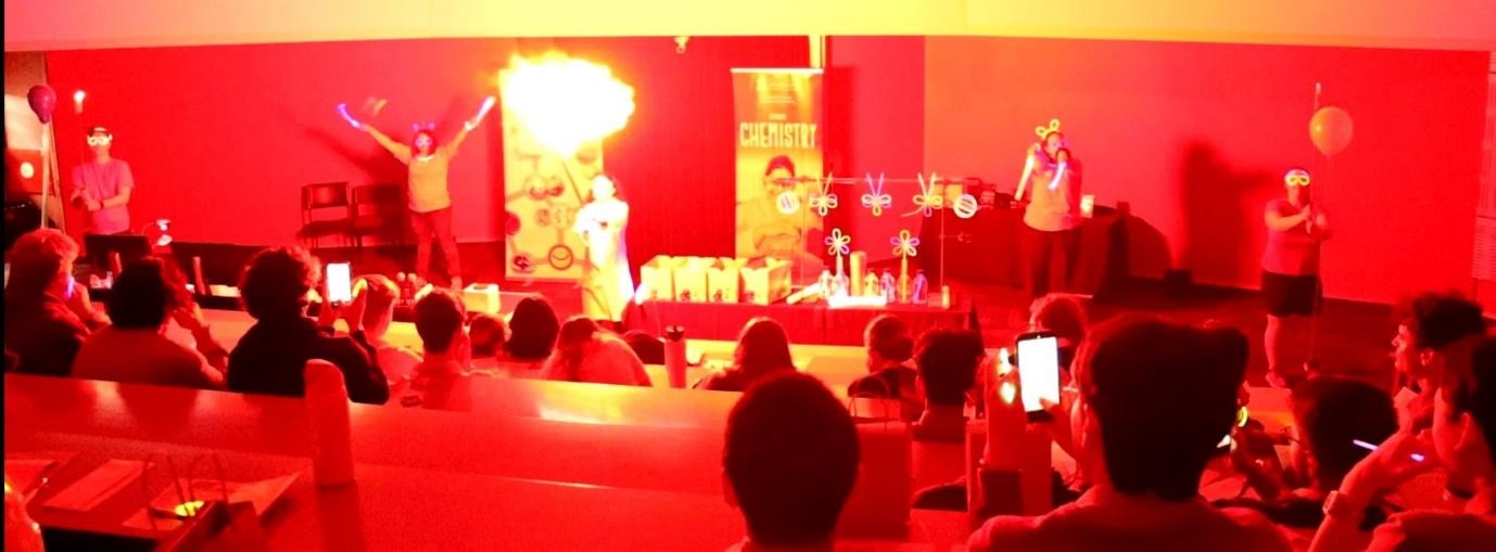 A group of people sitting in a roomAI-generated content may be incorrect.