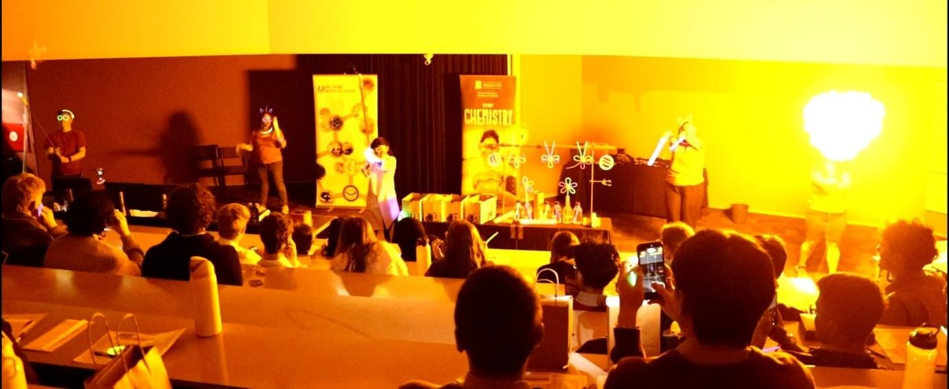 A group of people on a stageAI-generated content may be incorrect.