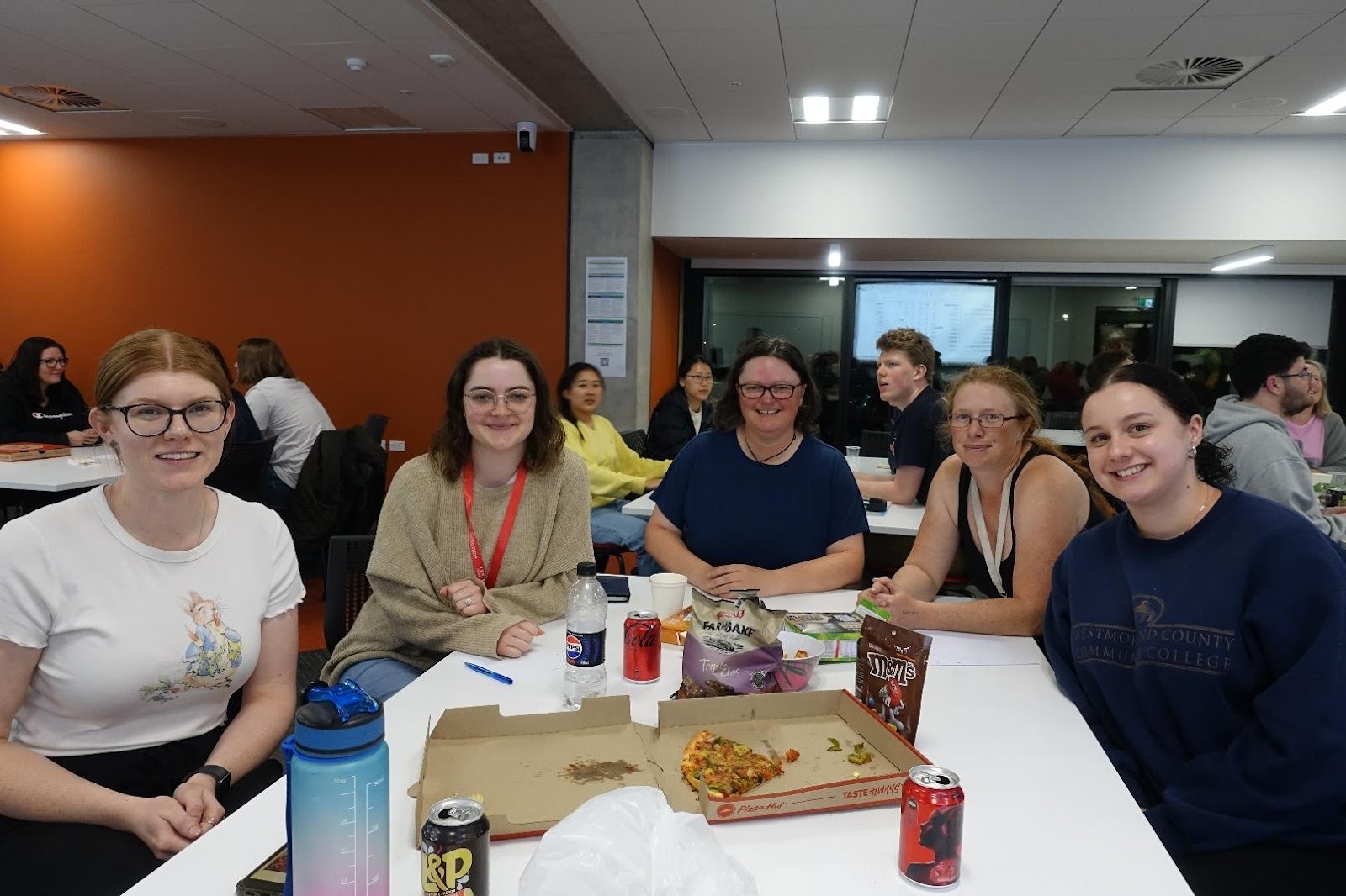 A group of people sitting at a tableAI-generated content may be incorrect.