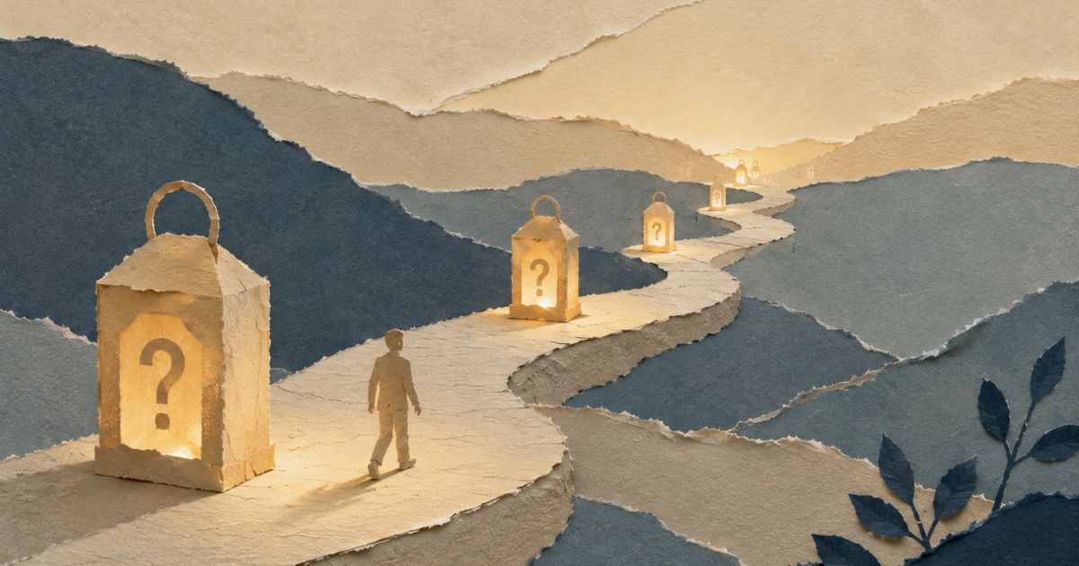 The Questions Great Coaches Ask. A handcrafted torn-paper collage illustration showing a winding pathway disappearing into the distance through layered paper hills. Along the path, softly glowing lanterns featuring subtle question-mark cutouts illuminate only the next few steps ahead. A small paper silhouette walks thoughtfully from one pool of light to the next while the final destination remains hidden. Warm cream, sand and muted blue-grey paper textures create a calm, reflective atmosphere symbolising growth, discovery and how powerful coaching questions help people find their own path forward one step at a time.