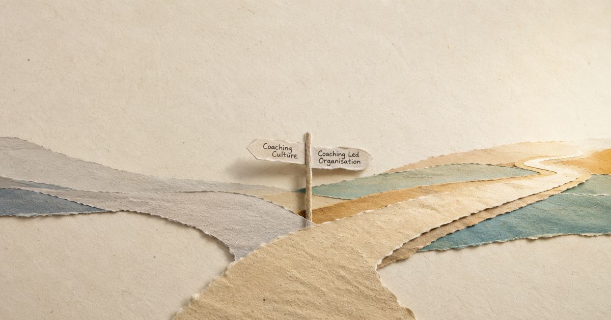 Minimalist torn paper landscape showing a path splitting at a signpost towards “Coaching Culture” and “Coaching Led Organisation”.