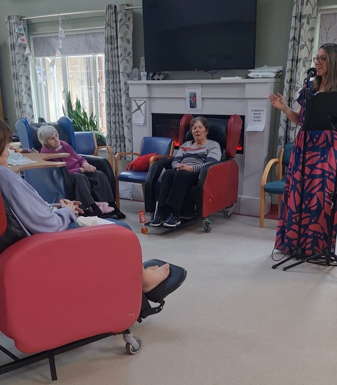 A singer entertains a group in a nursing home