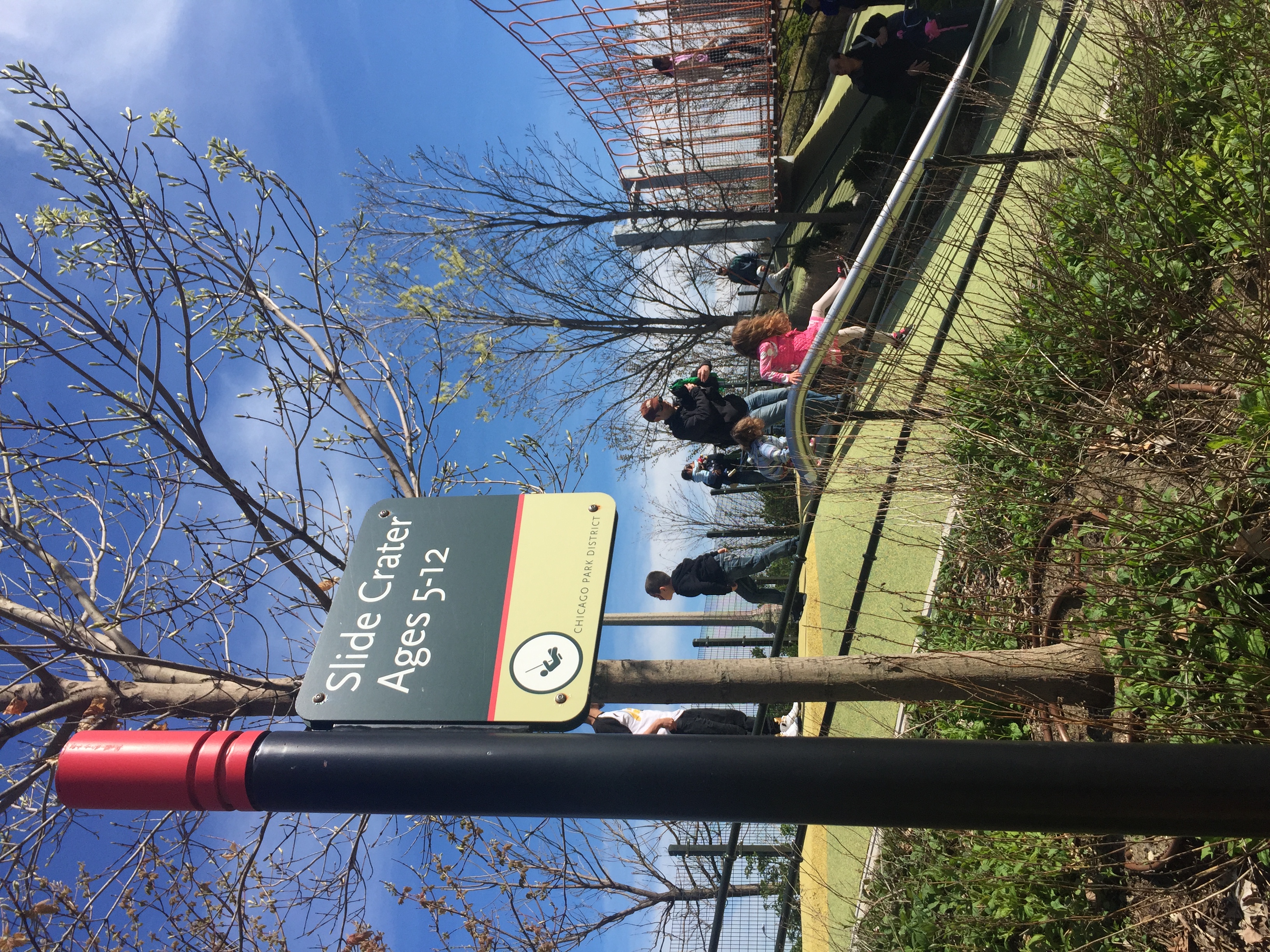 Chicago Park System exterior post-mounted blade sign identifying Slide Crater playground area with icon, designed by Two Twelve