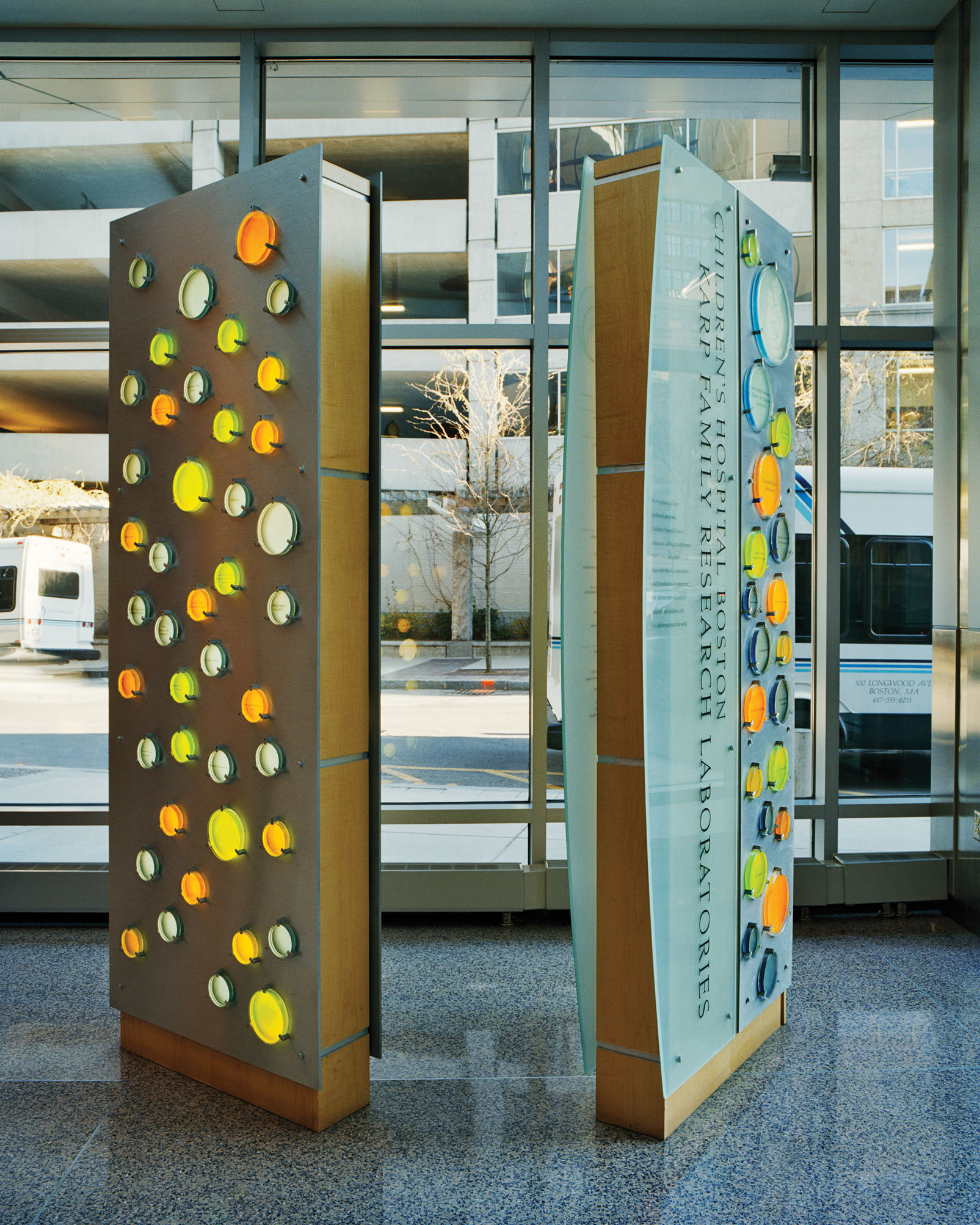 Children's Hospital Boston interior donor wall detail with color-coded circular acrylic donor names on stainless steel, designed by Two Twelve