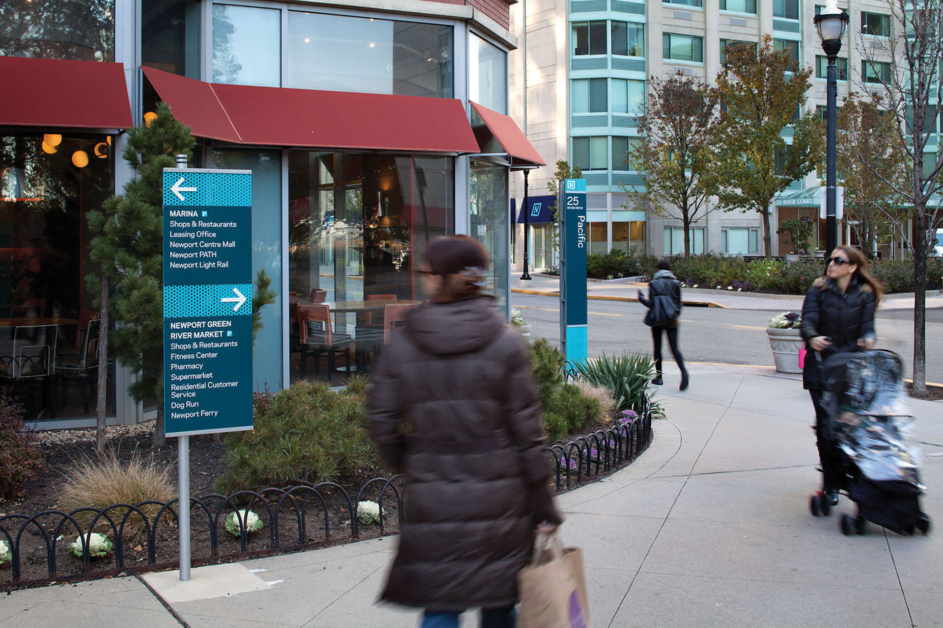 Community of Newport exterior post-mounted directional sign for Marina and River Market with blue perforated material, designed by Two Twelve