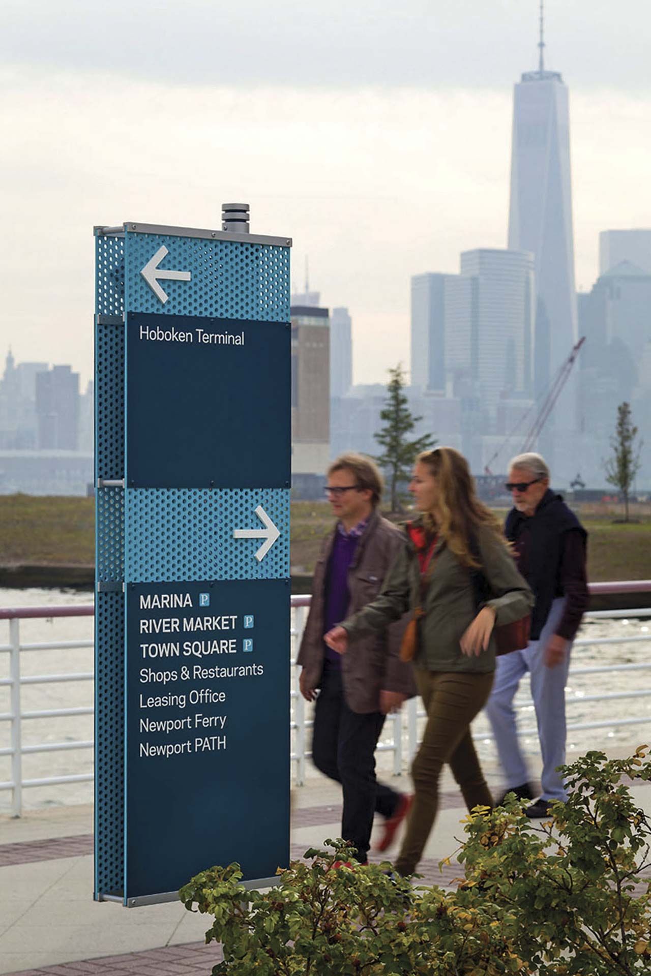 Community of Newport exterior post-mounted directional sign with blue perforated material, designed by Two Twelve
