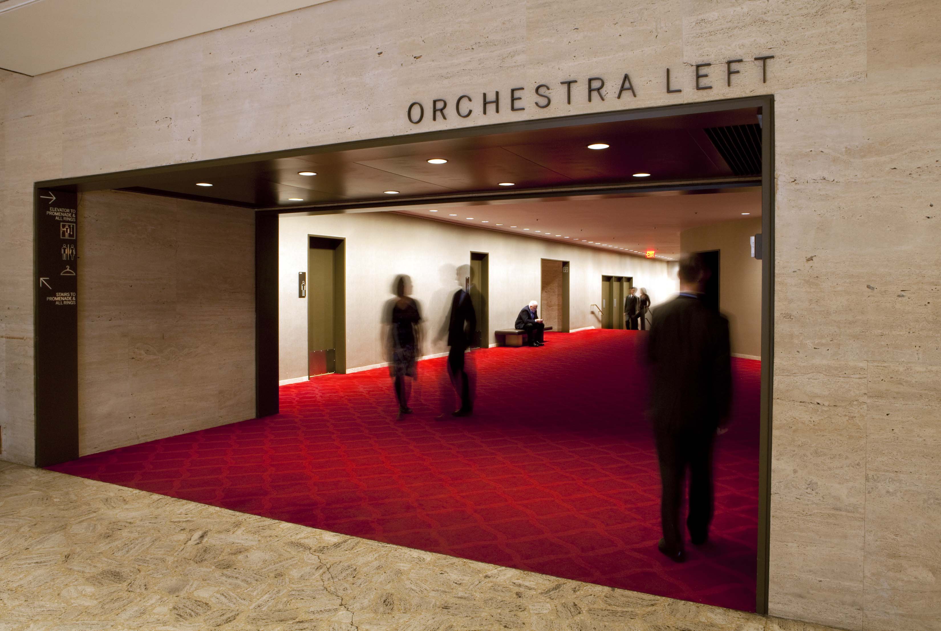 David H. Koch Theater at Lincoln Center interior identification sign for orchestra entrance with black dimensional lettering on stone, designed by Two Twelve