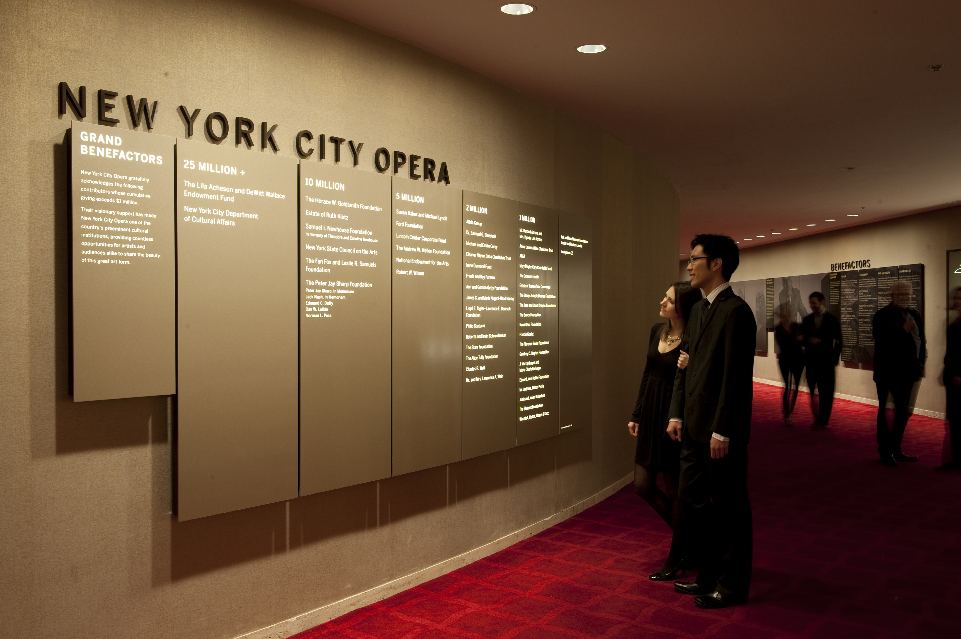 David H. Koch Theater at Lincoln Center interior donor wall with backlit illuminated panels and dimensional identification sign, designed by Two Twelve