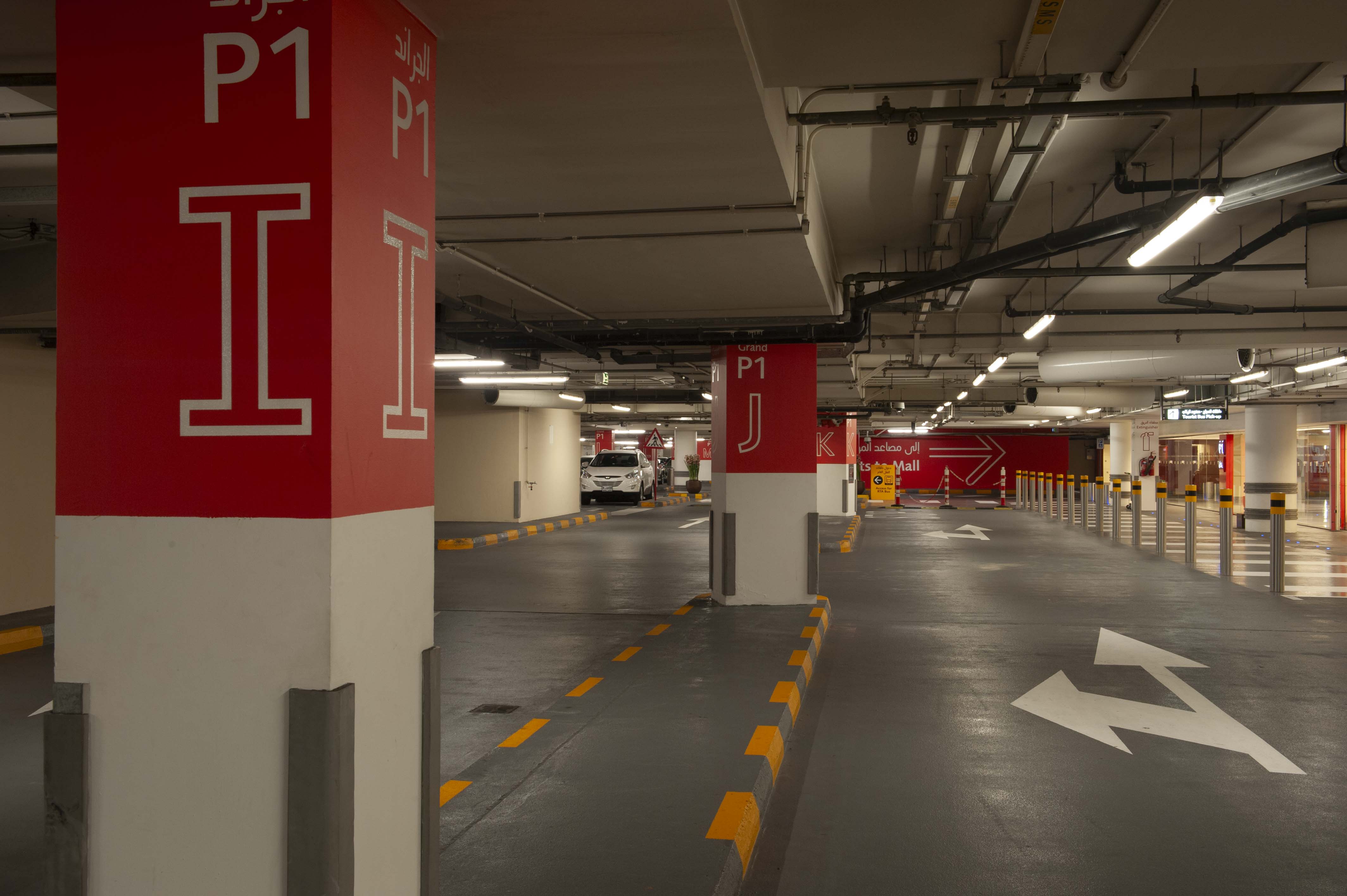 Dubai Mall interior parking garage column identification and wayfinding signs in red, designed by Two Twelve