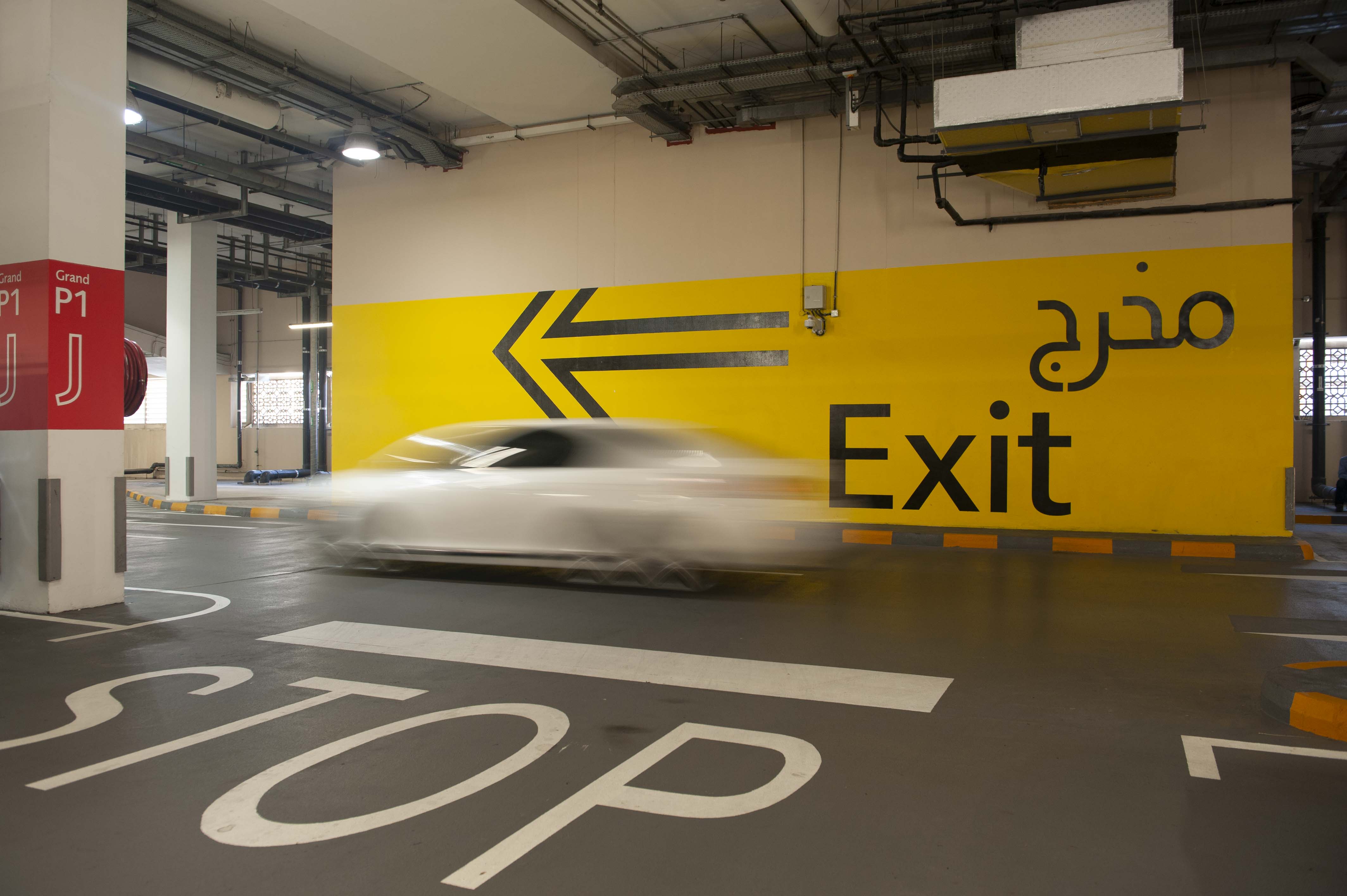 Dubai Mall large interior vehicular supergraphicsgarage exit directional sign painted on wall, designed by Two Twelve