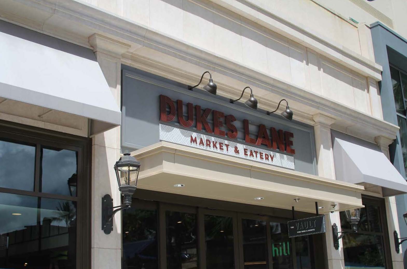 Dukes Lane Market exterior identification entrance sign with dimensional wall-mounted letters above doorway, designed by Two Twelve