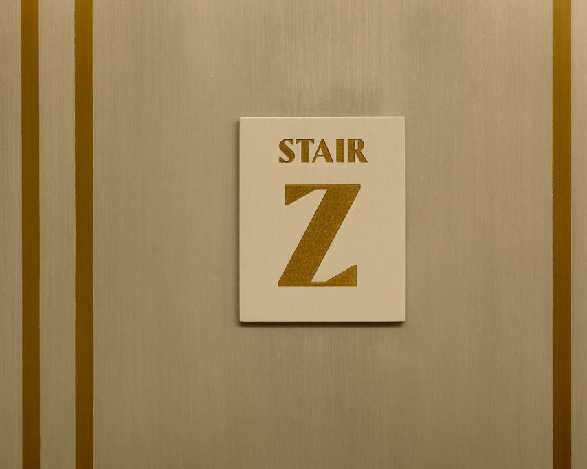 Empire State Building interior wall-mounted staircase identification sign, designed by Two Twelve